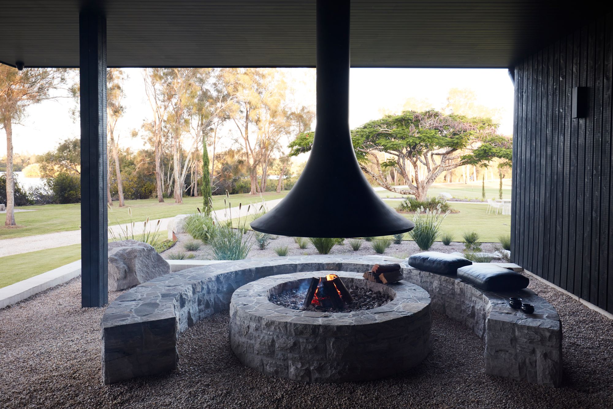 Micalo by Byron Beach Abodes showing exterior outdoor fireplace with stone clad seating