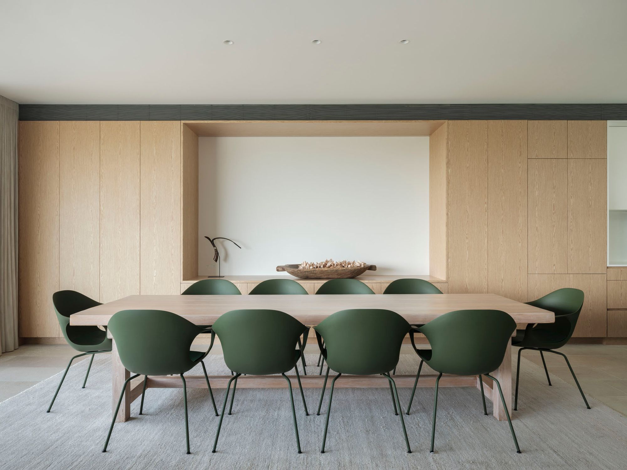 Northbridge by Corben Architects showing interior of dining room with green dining chairs