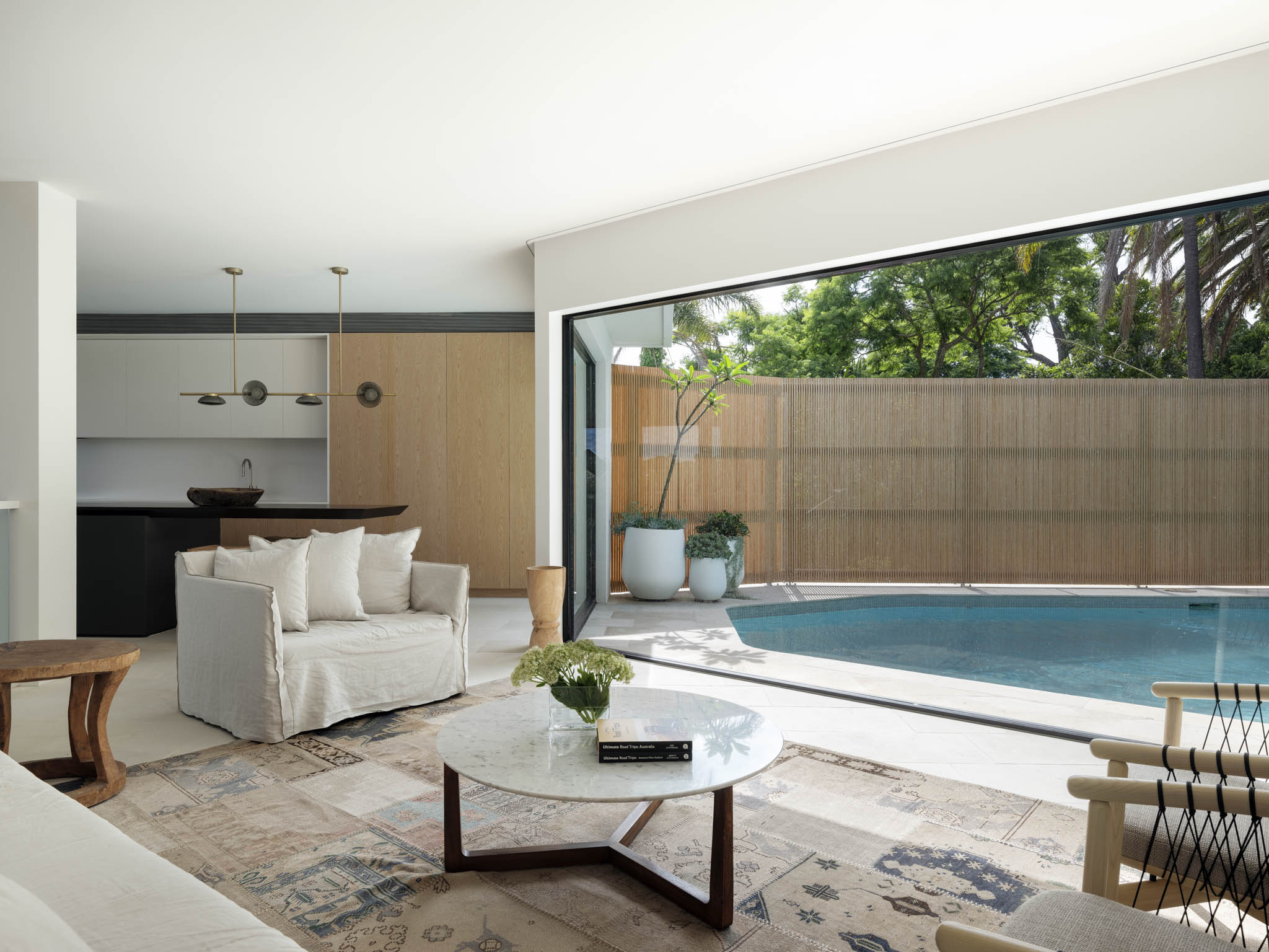 Northbridge by Corben Architects showing living room overlooking pool
