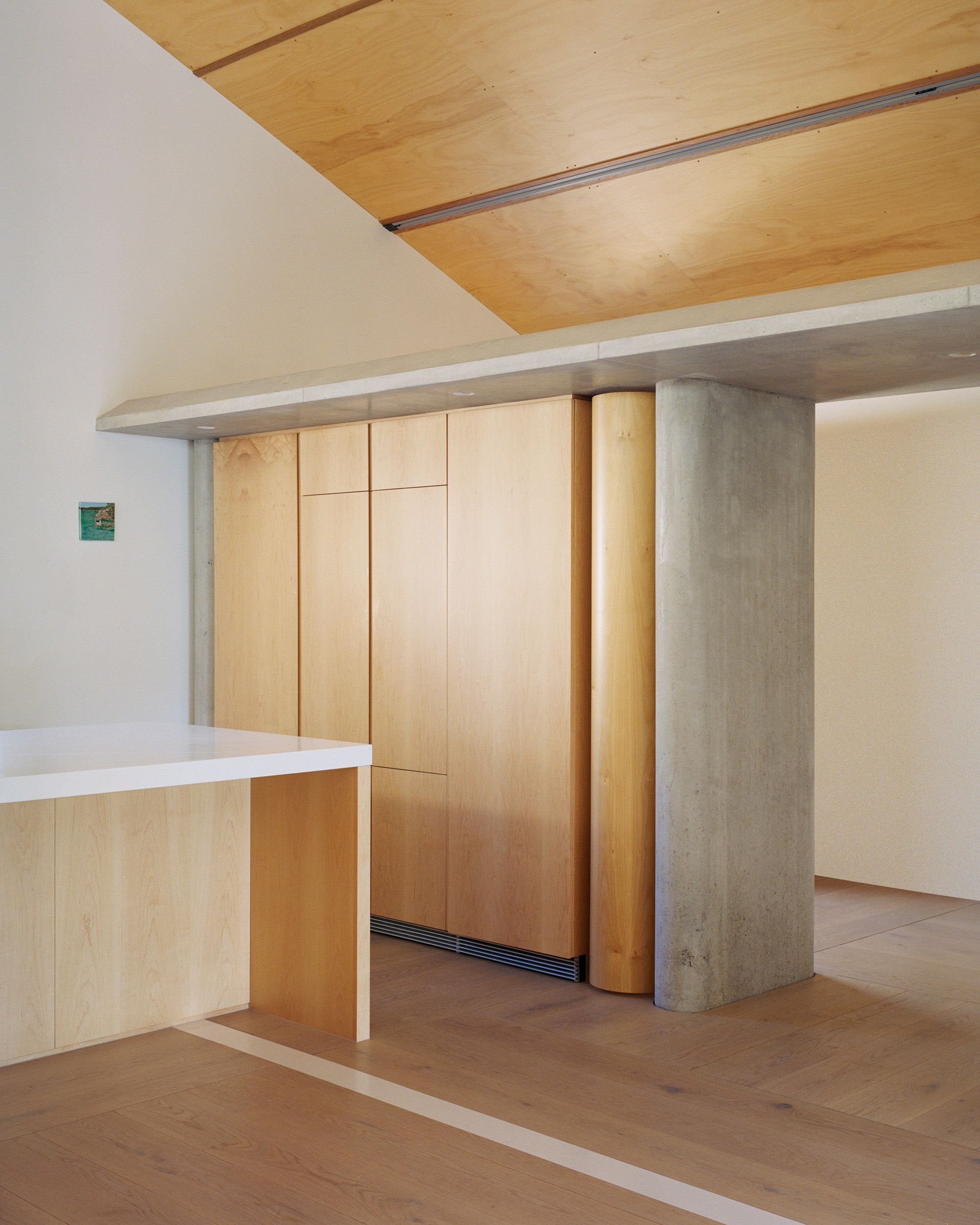 Lee House by Candalepas Associates. Kitchen and dining area, featuring elements of the old wall that were originally there.