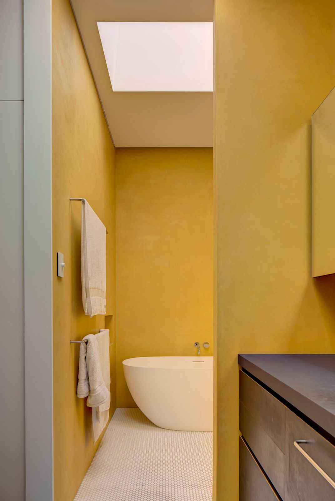 Sky House by Marra+Yeh Architects showing yellow bathroom with feature bath tub