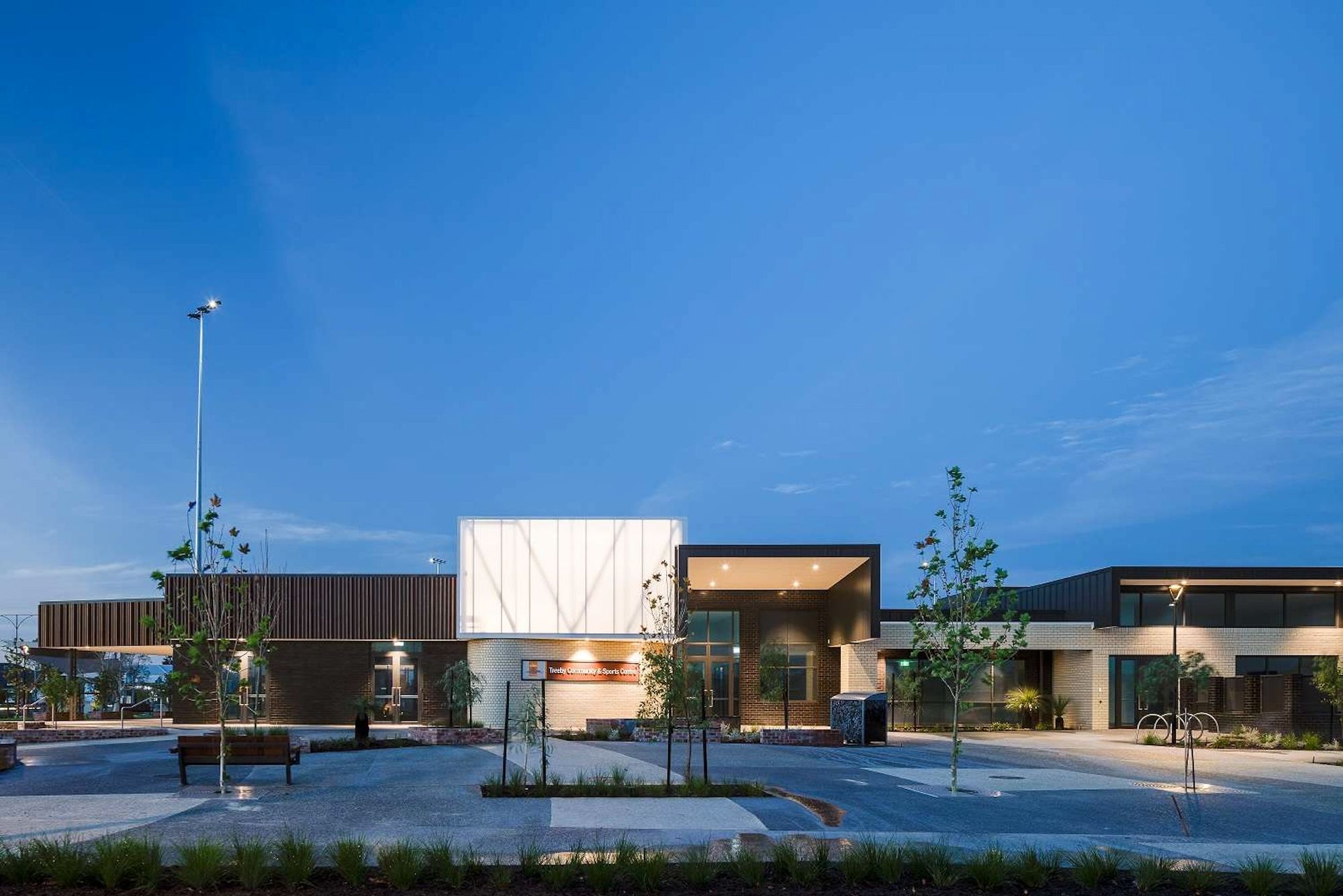 Treeby Community & Sports Centre showing building lit up at dusk