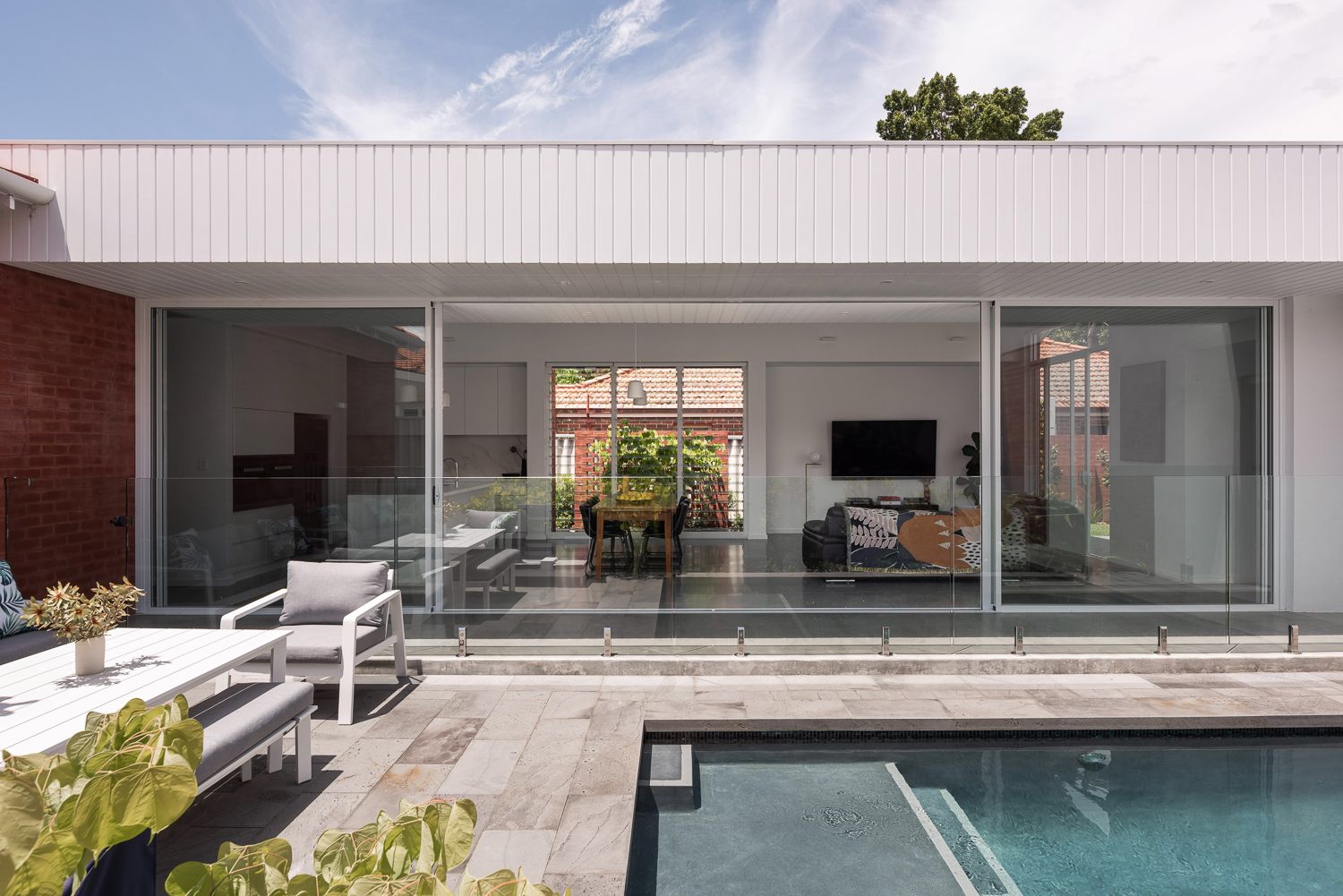 Inglewood House by Robeson Architects. Exterior rear facade of modern residential property with outdoor entertaining area and pool.  