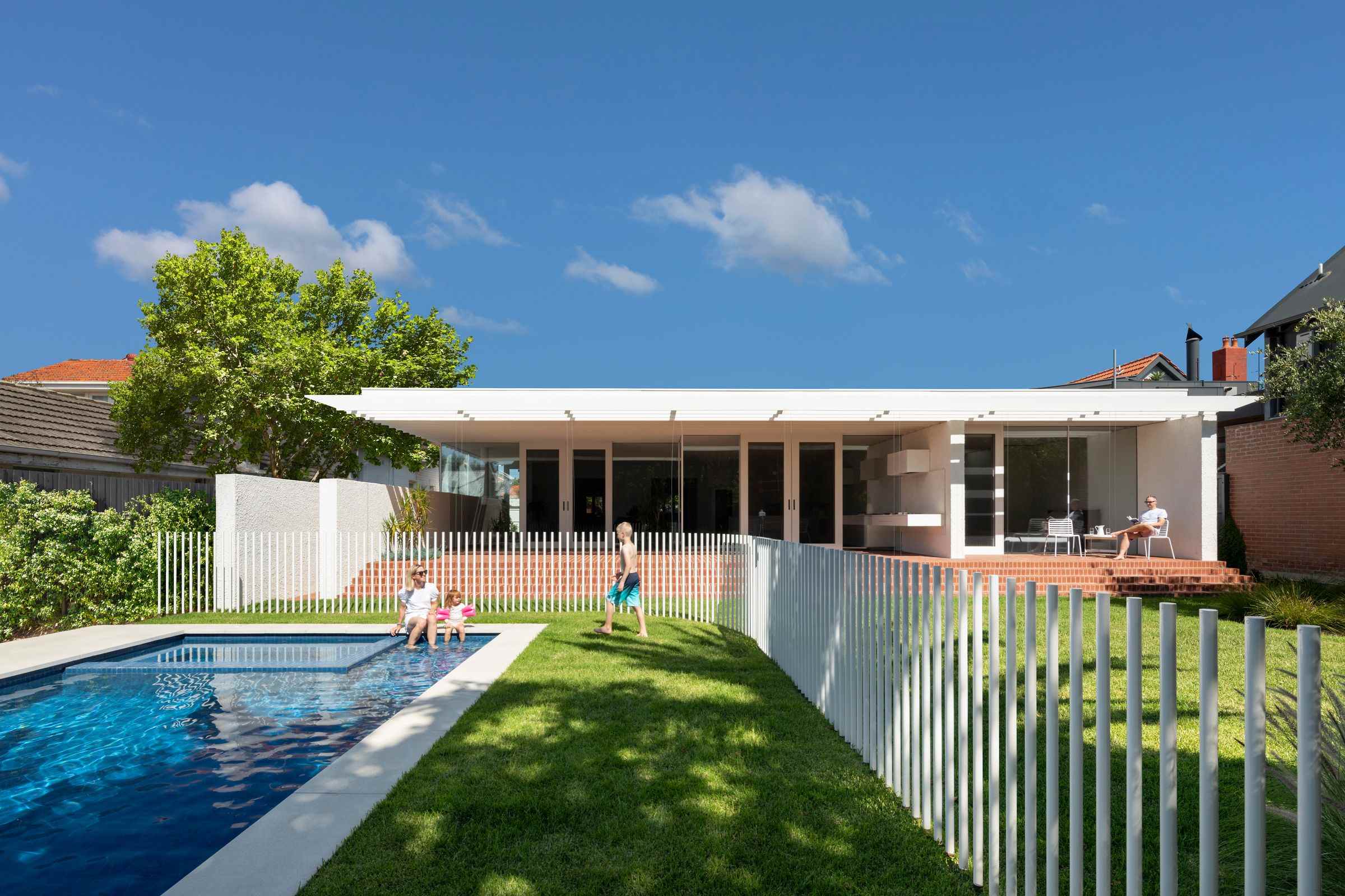Elwood House by AM Architecture showing backyard view of new addition and pool