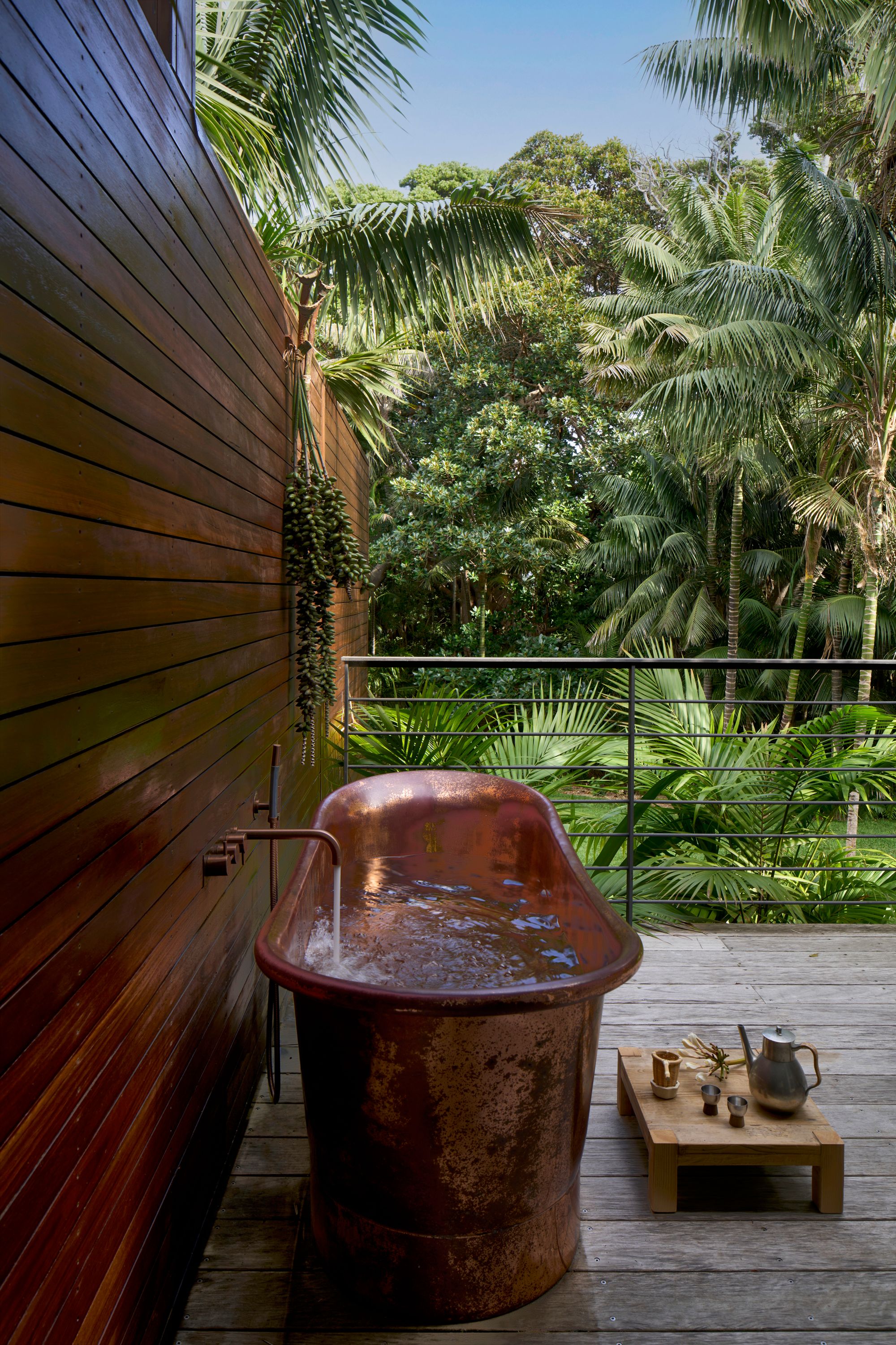 Island House, Lord Howe Island showing outdoor bath on timber deck looking out to tropical garden