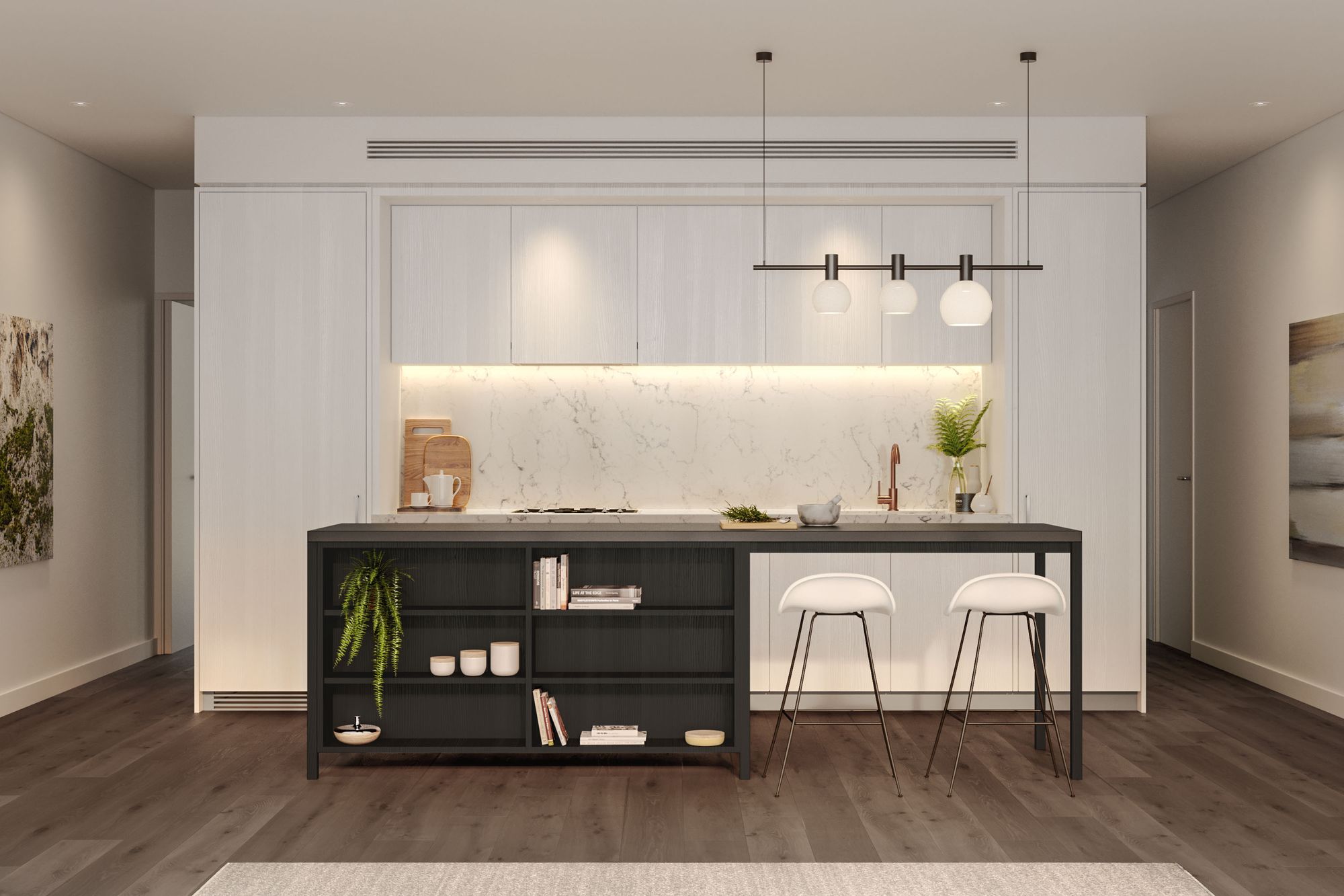 The image depicts a modern and minimalist kitchen interior. The design primarily uses neutral tones with a mix of light wooden cabinetry and a dark kitchen island. The marble backsplash adds a touch of luxury, contrasting with the sleek lines of the cabinetry. The kitchen island features an open shelving unit on one side, which houses books, decorative ceramics, and a potted fern. Above the island hangs a contemporary light fixture with three white, round shades. Two elegant white barstools sit in front of the island, inviting casual dining or conversation. On the left, a textured artwork adds depth and character to the space. Soft, ambient lighting and clean lines create a calm and sophisticated atmosphere.