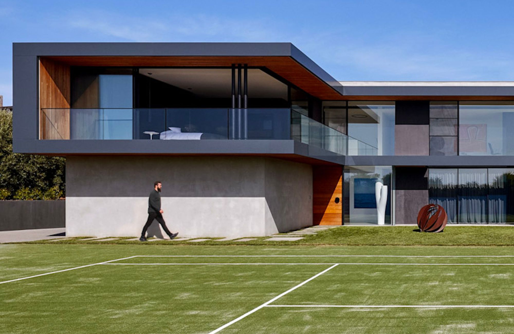 Portsea by Piccolo Architecture showing exterior of a house and a tennis court in the foreground