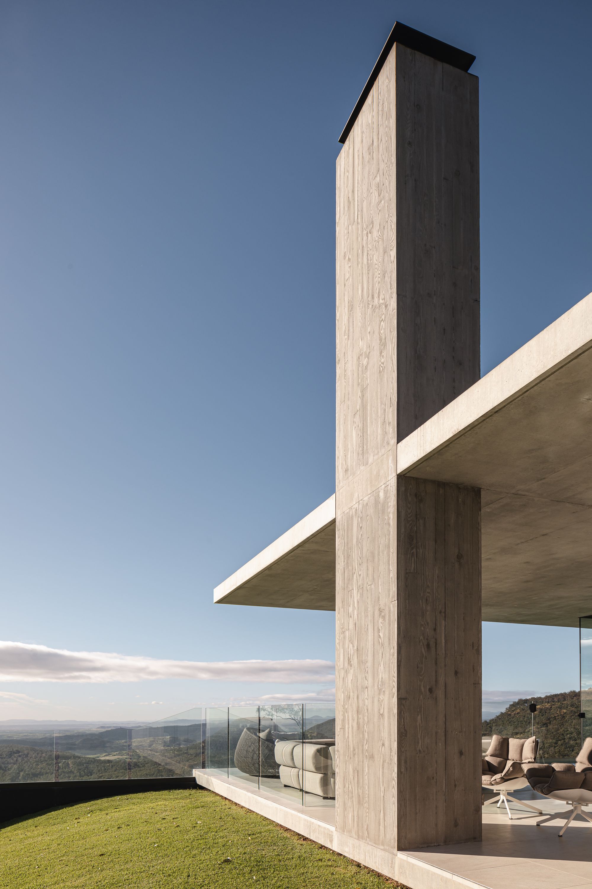 Cliffhanger by Joe Adsett Architects showing a close up view of the concrete chimney and outdoor space