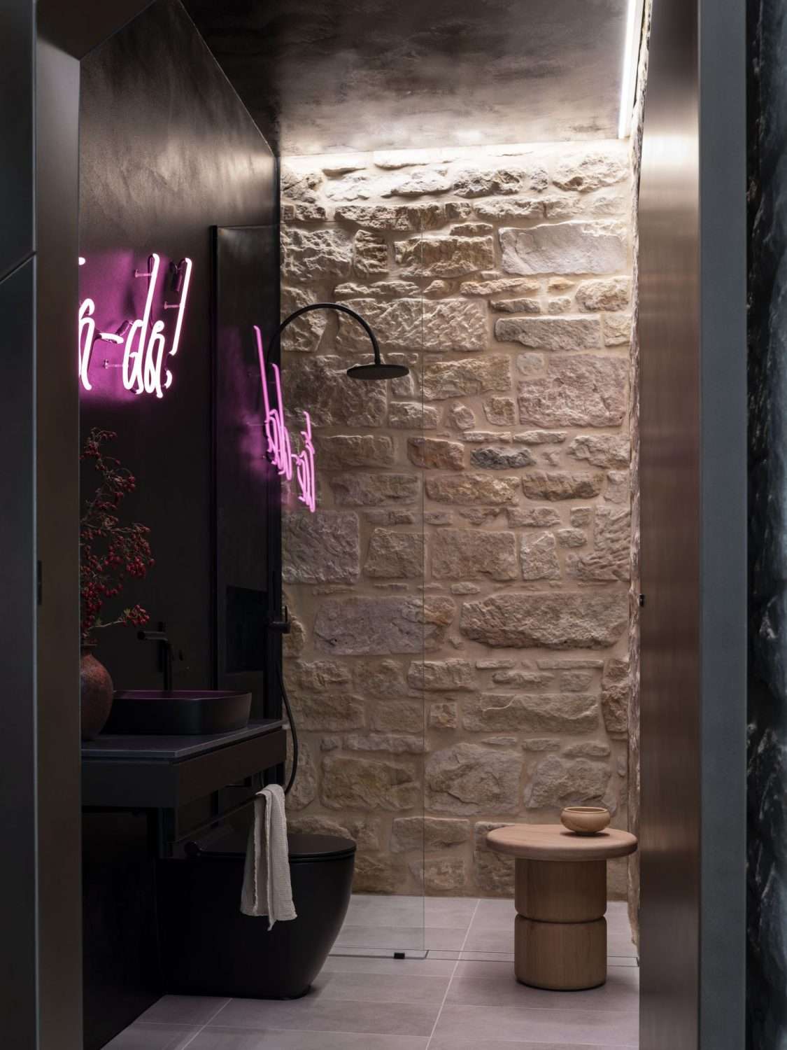 Maranatha House by BIJL Architecture showing internal view of the bathroom with exposed sandstone wall