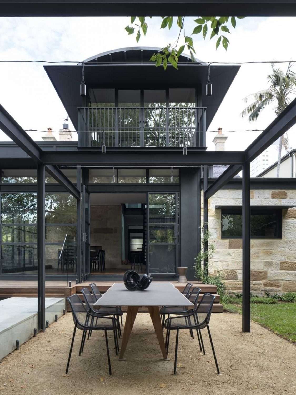 Maranatha House by BIJL Architecture showing an exterior courtyard and outdoor dining area