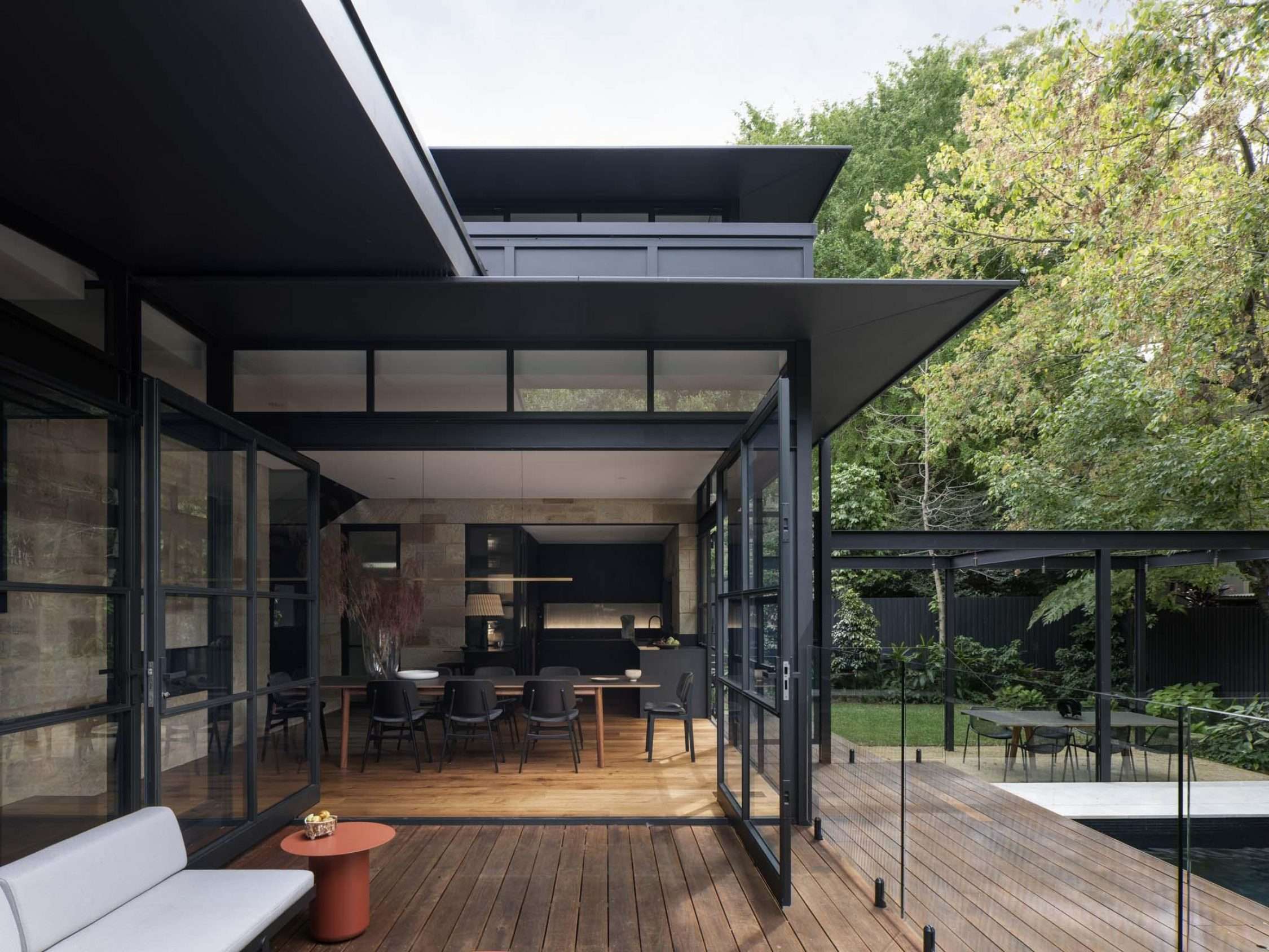 Maranatha House by BIJL Architecture showing inside outside connection to deck and pool area from the kitchen / dining space