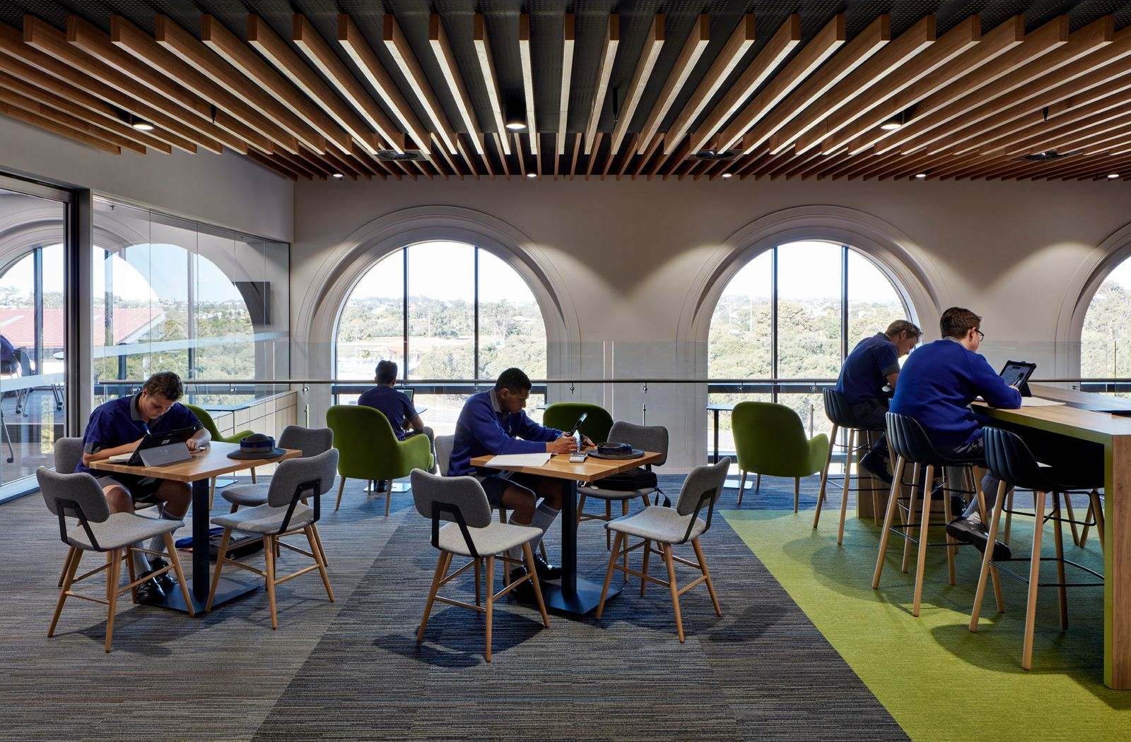 Anglican Church Grammar School Centenary Library by BSPN Architecture showing interior of school with school kids working