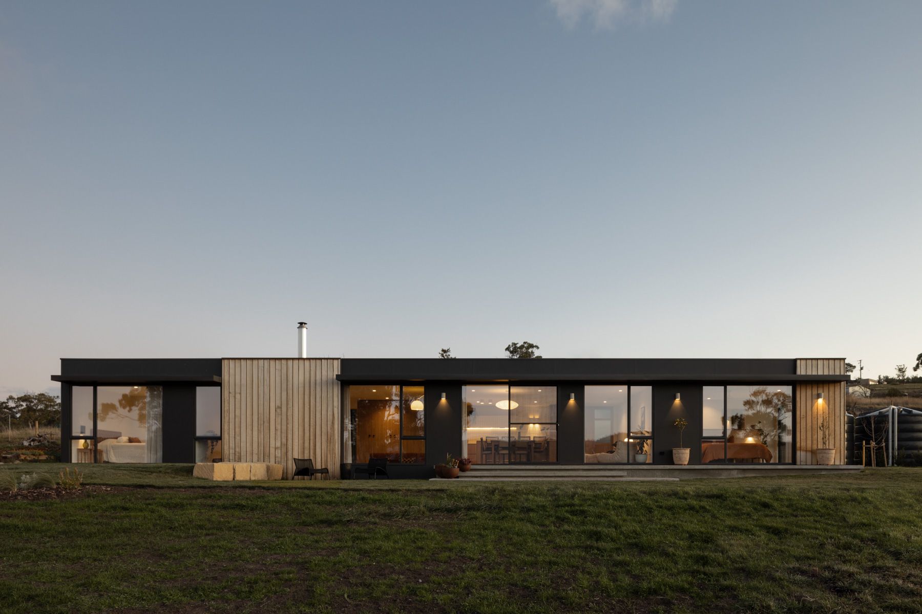 We Ponder House by Saxon Hall Architecture with Align Architecture showing the rear elevation at dusk
