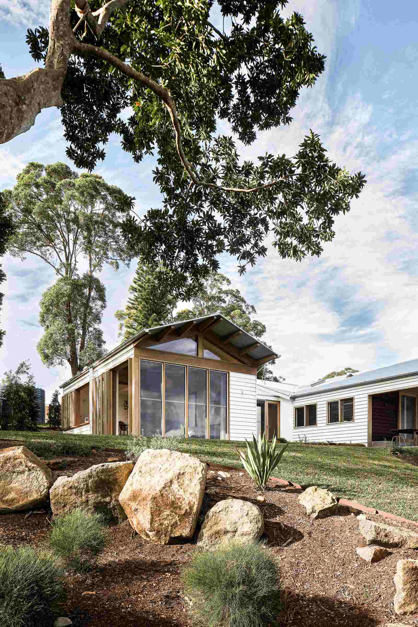 The Caretaker's by Aphora Architecture showing the landscaped garden of the house in Byron