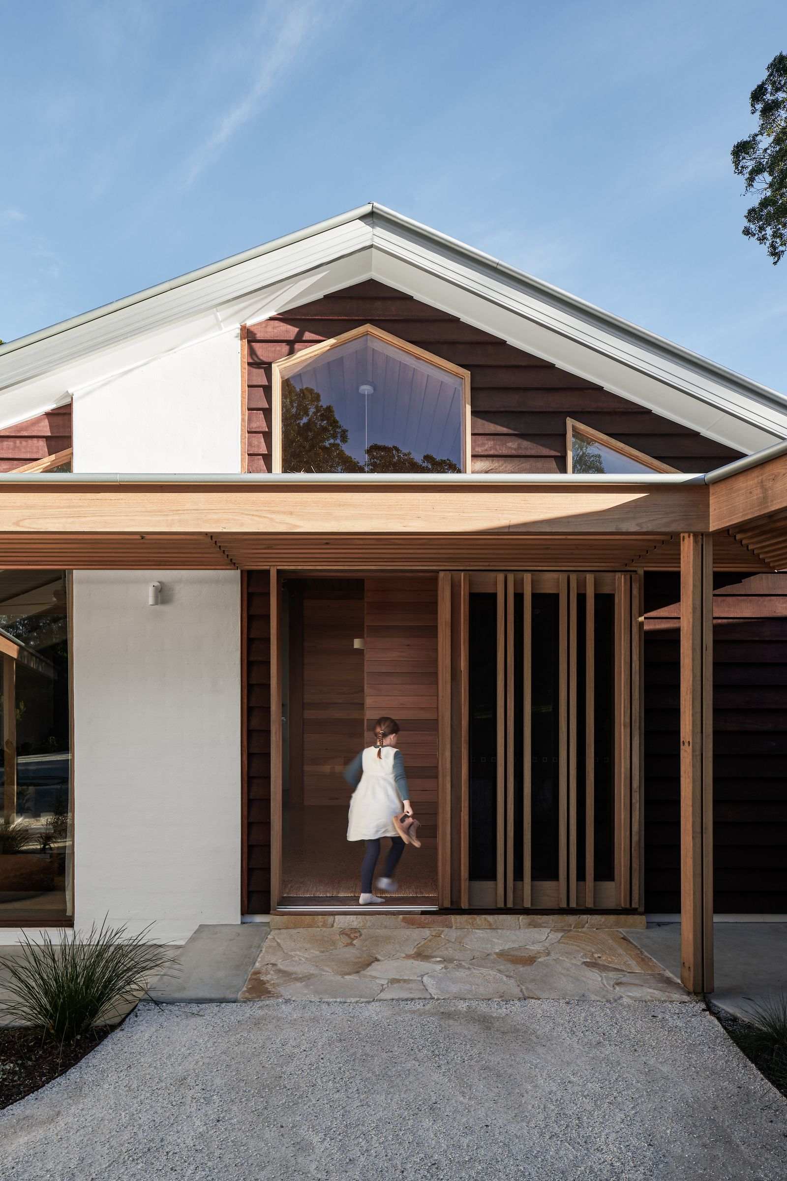 The Caretaker's by Aphora Architecture showing the front entry door made out of timber
