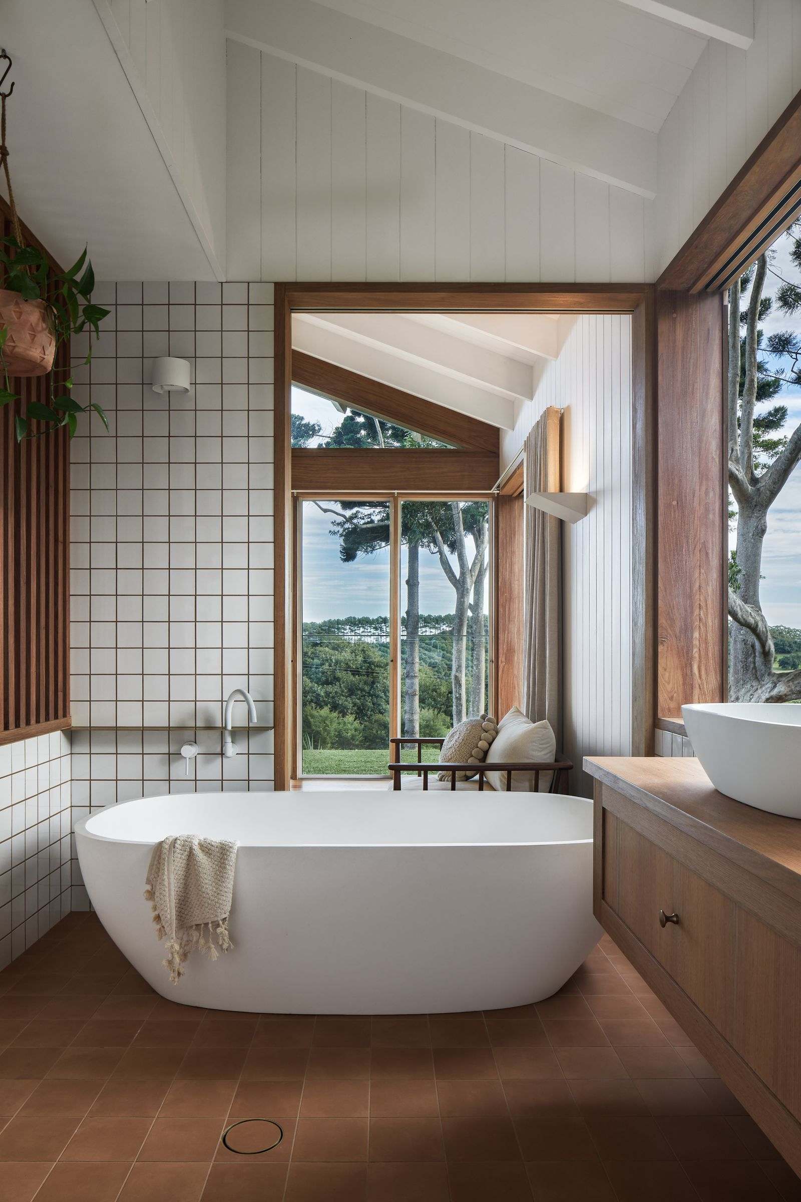 The Caretaker's by Aphora Architecture showing the freestanding bath tub with a view out to the rolling hills