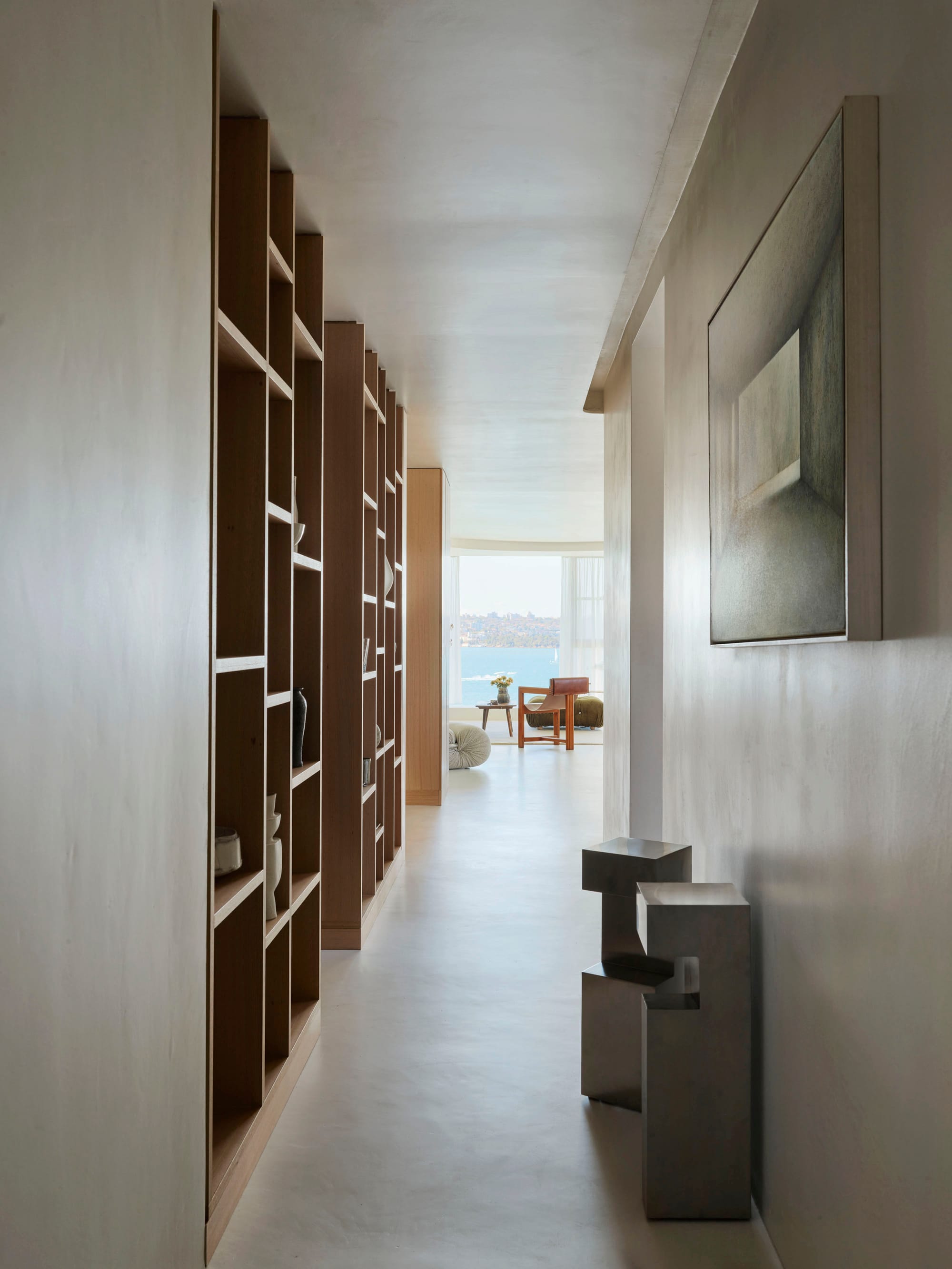 An interior shot of the hallway in this modern apartment with distant harbour views in the background