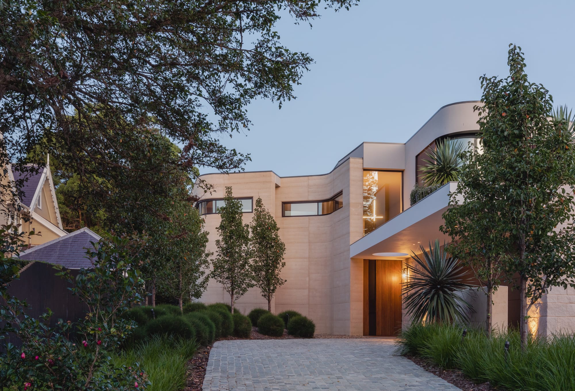 Kenneth Street by Design Studio Group showing the driveway and entry to the house