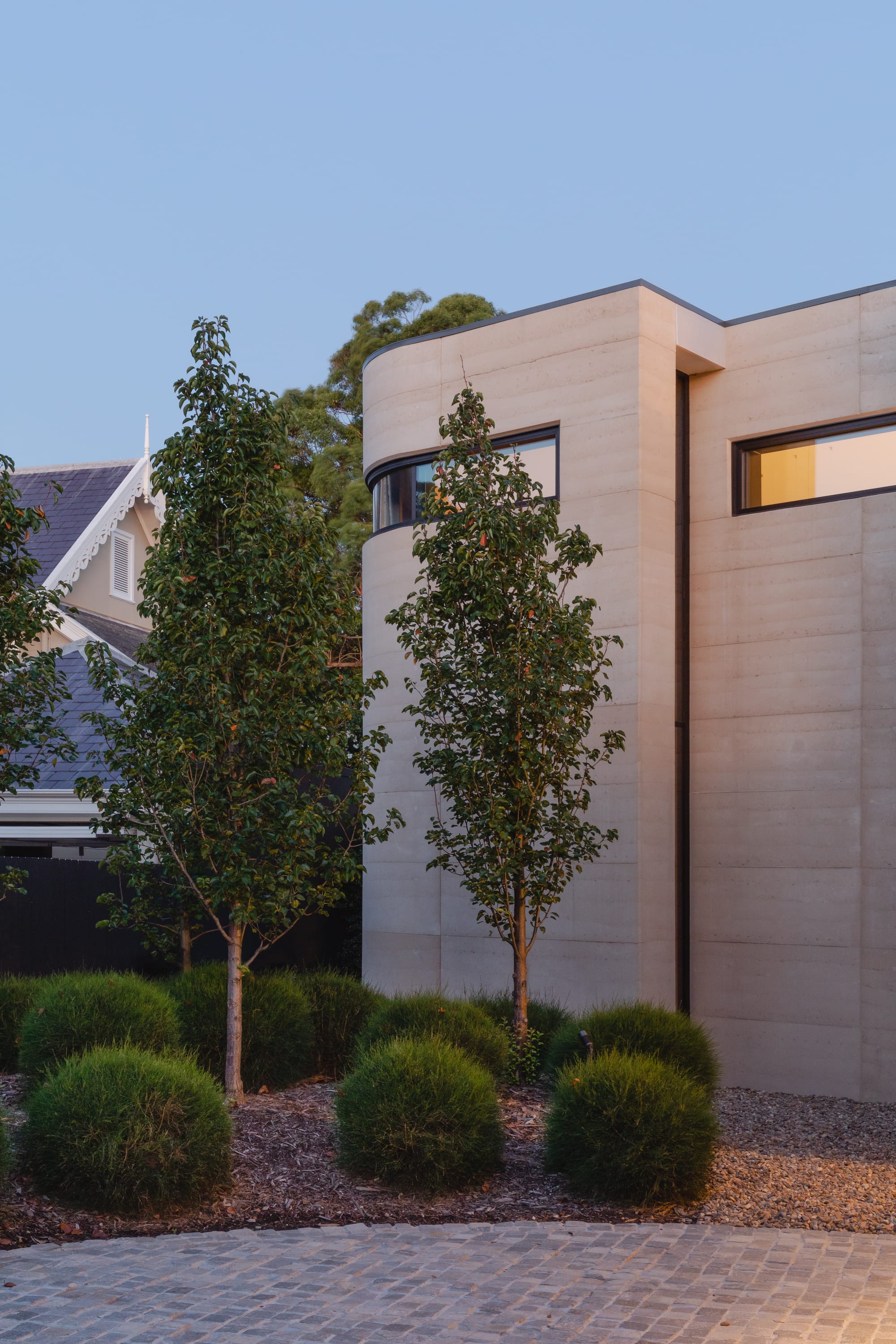 Kenneth Street by Design Studio Group showing the exterior rammed earth walls and landscape