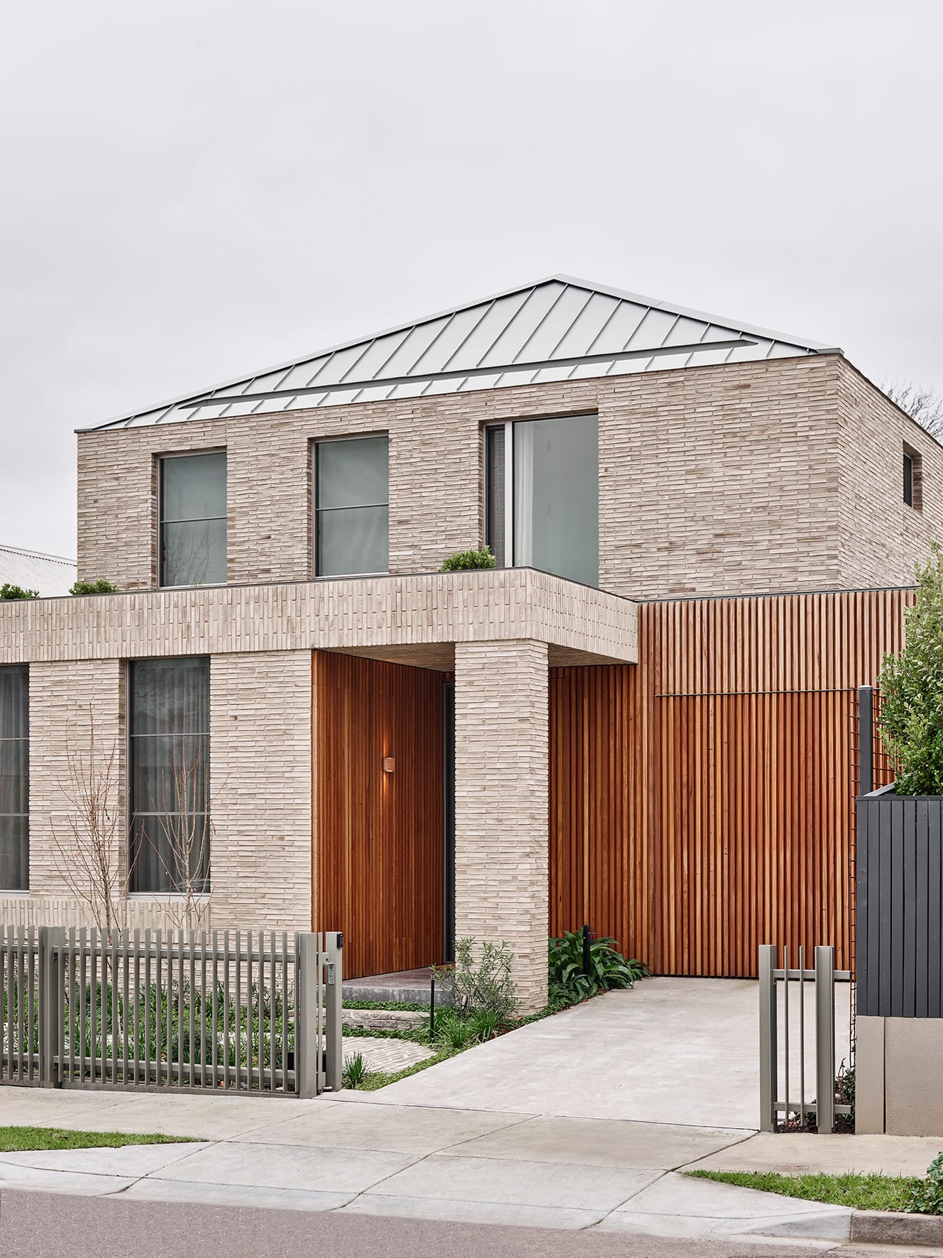Terra Firma by RobsonRak showing the street facade with brickwork and timber cladding