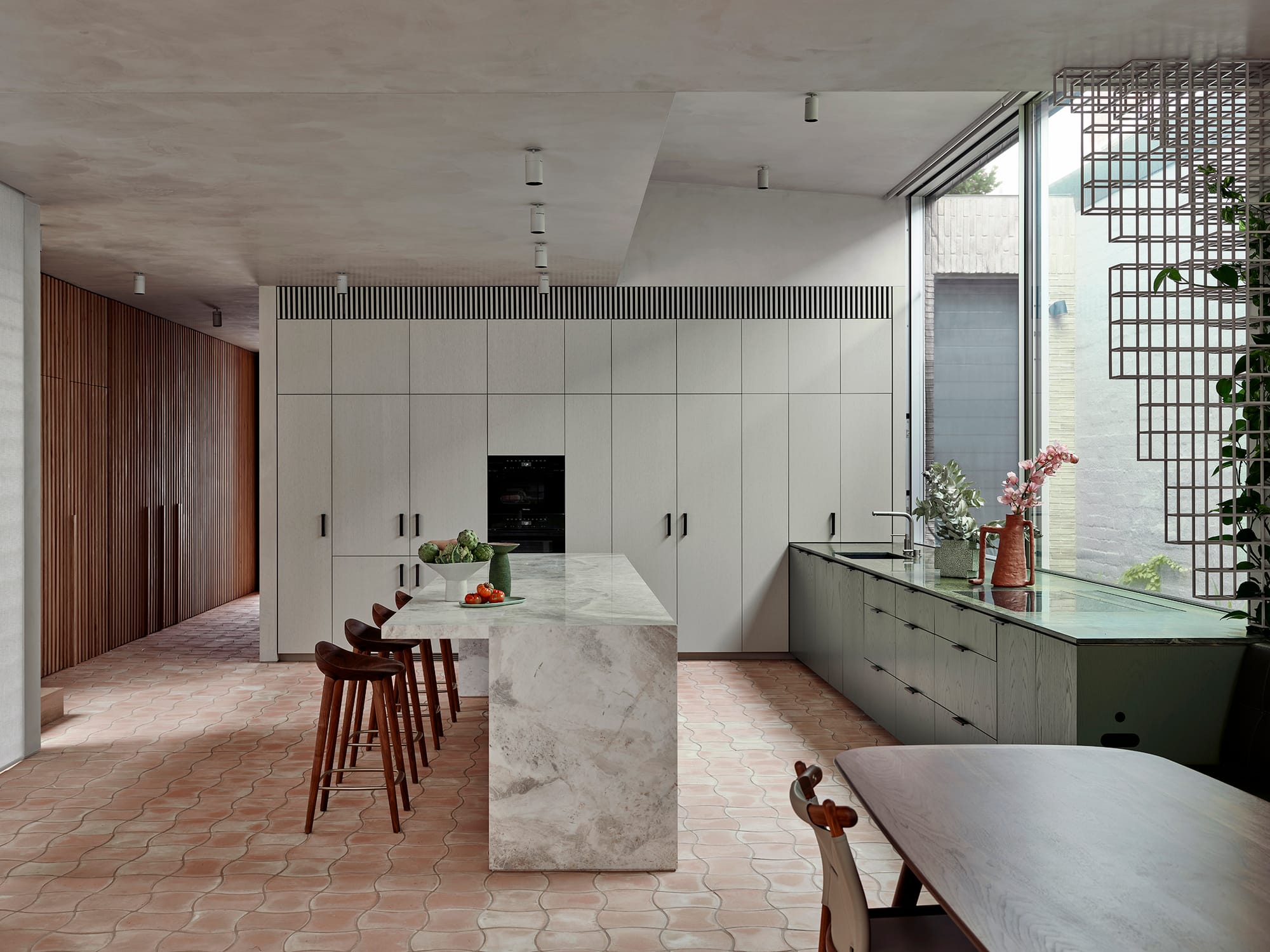 Terra Firma by RobsonRak. Photography by Mark Roper showing the kitchen interior and island bench