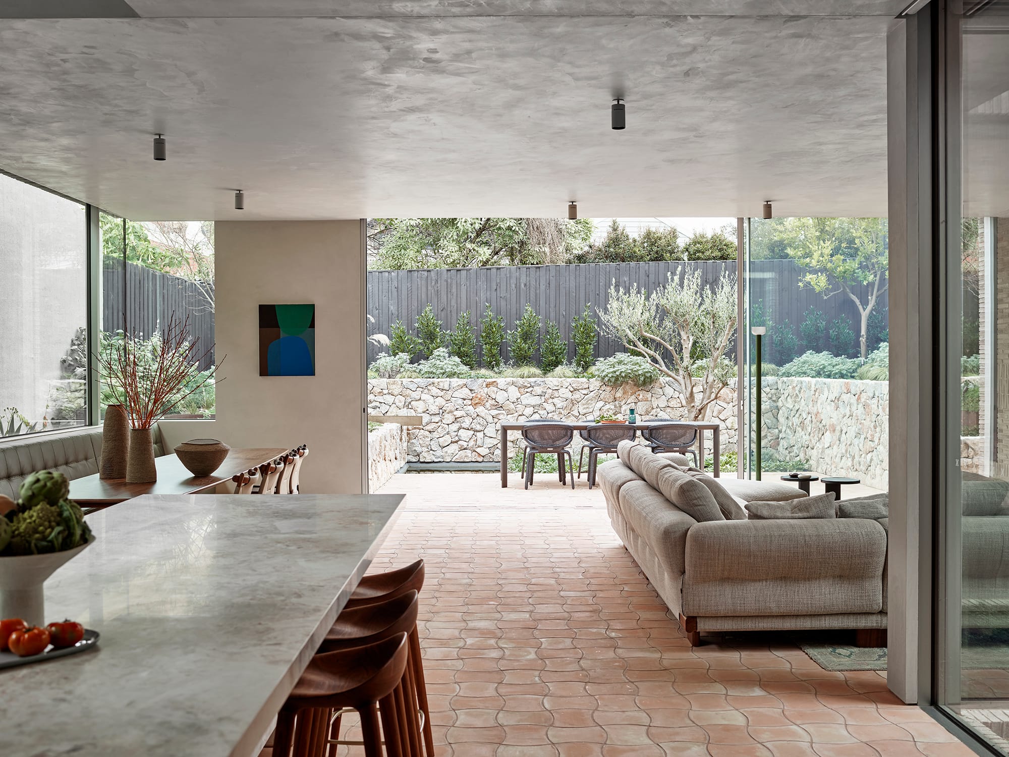 Terra Firma by RobsonRak. Photography by Mark Roper showing the interior of the open living space of this new house and the connection to the backyard
