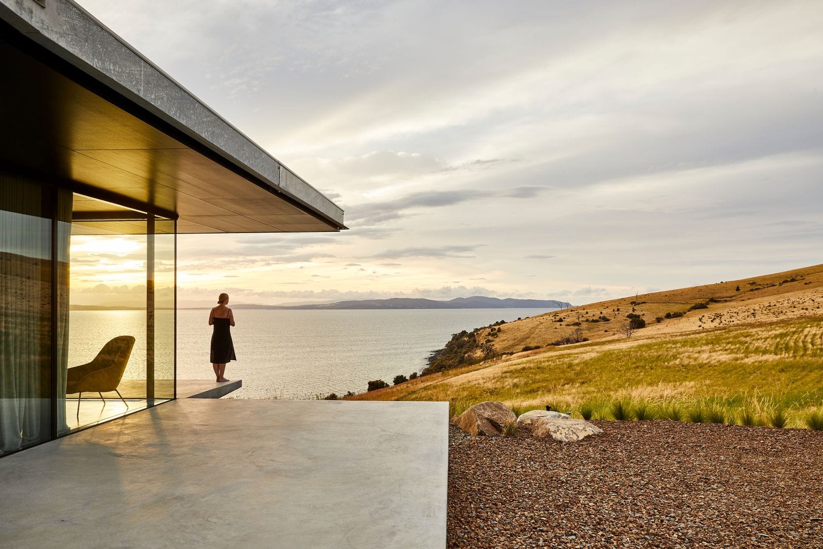 The Point Tasmania showing the ocean outlook at sunset and the concrete house in the foreground