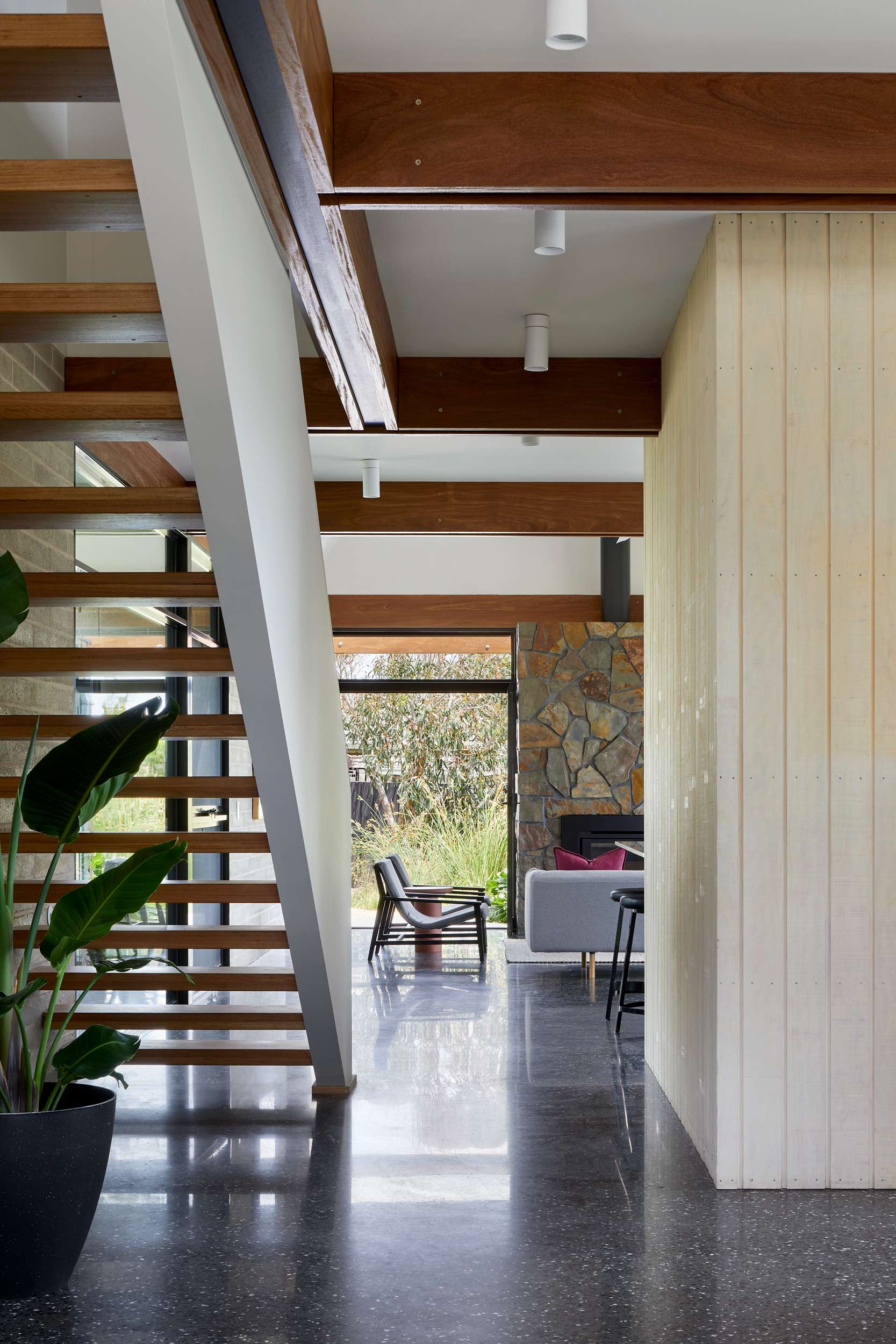 An interior shot of this house showing the open staircase and views out to the landscape in the background