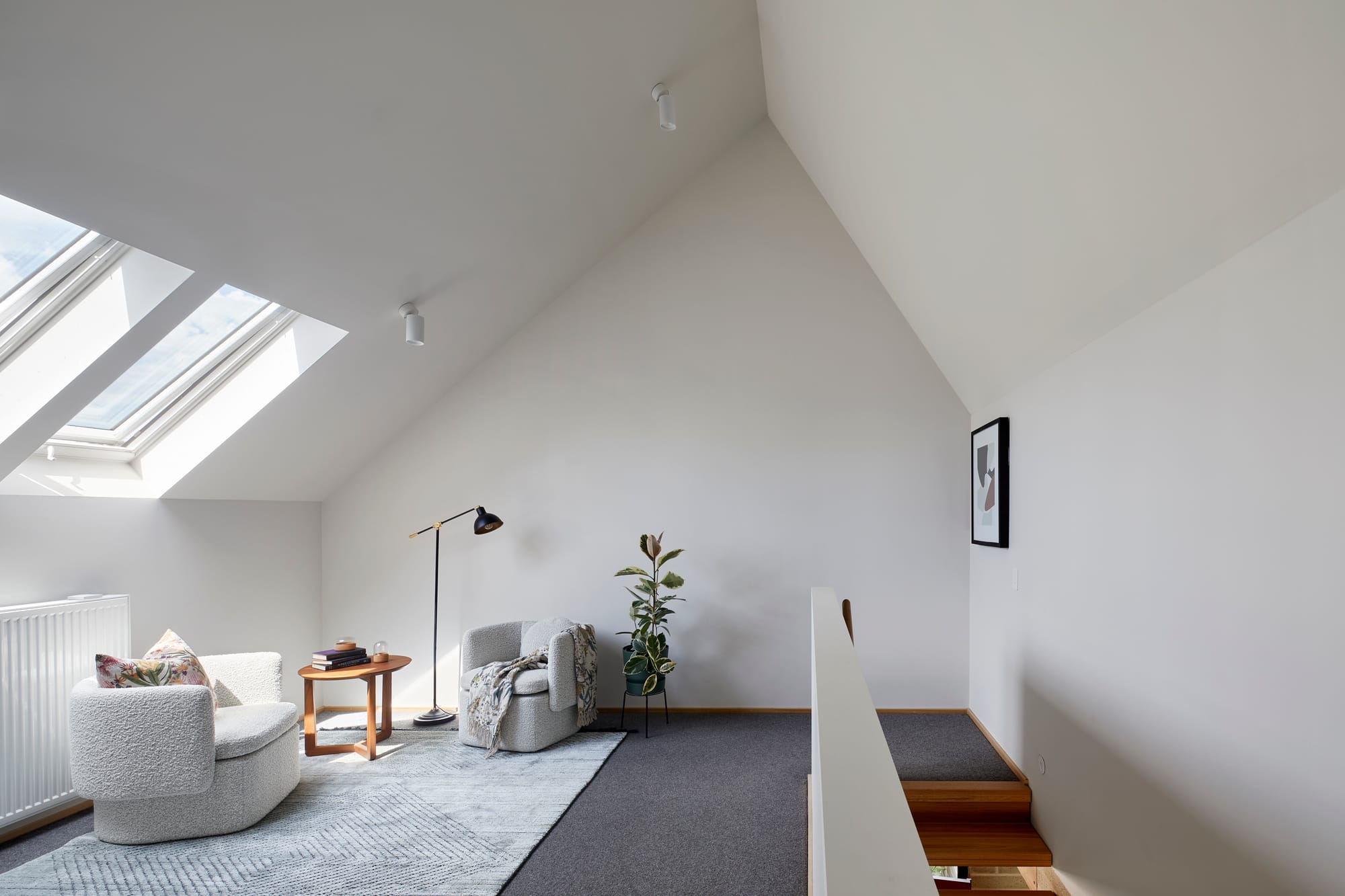 An interior view of the loft space with white plasterboard walls and high ceilings