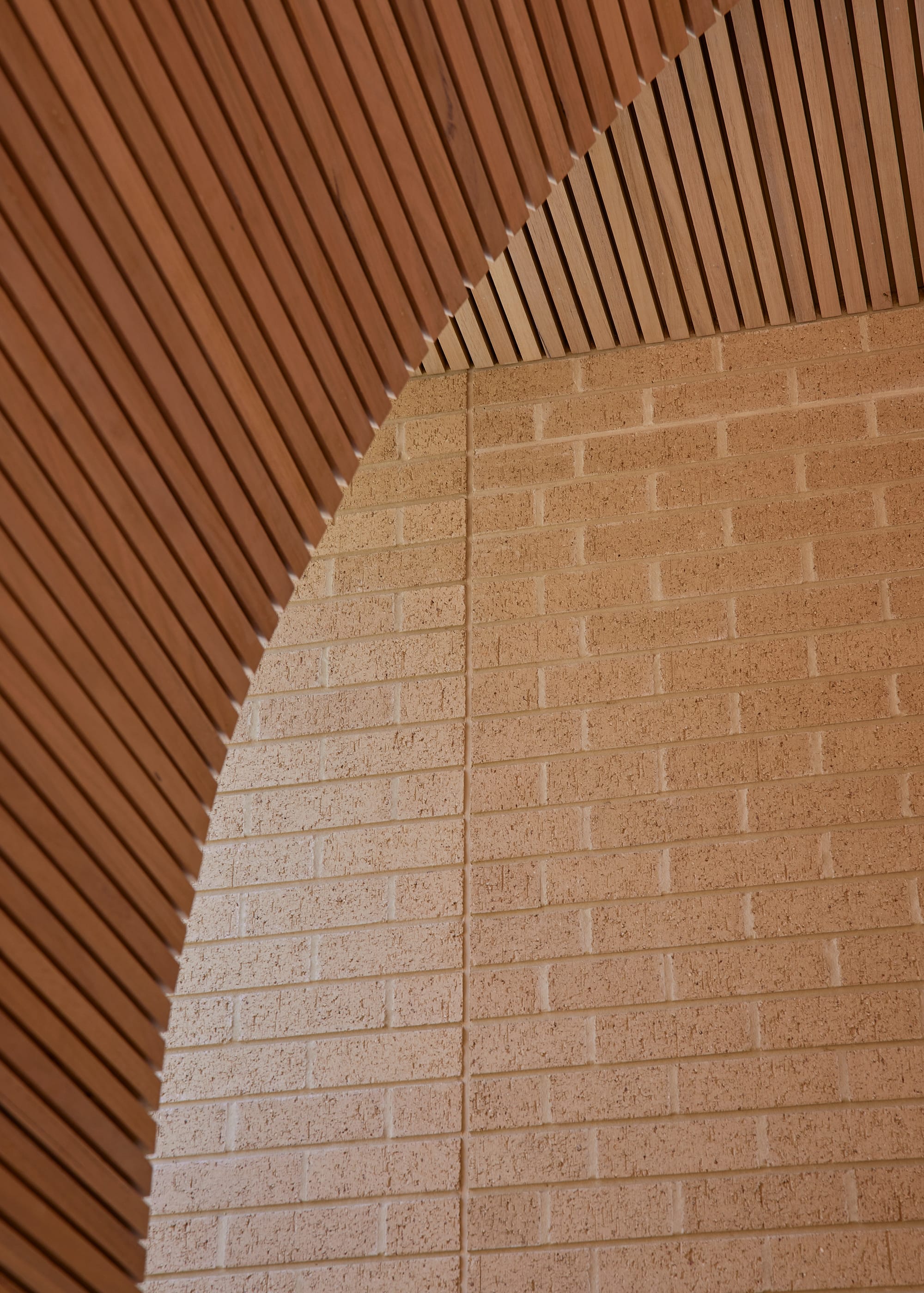 Harriet's House by SO:Architecture. Photography by Sean Fennessy. Close up or curving timber clad ceiling meeting brick walls.