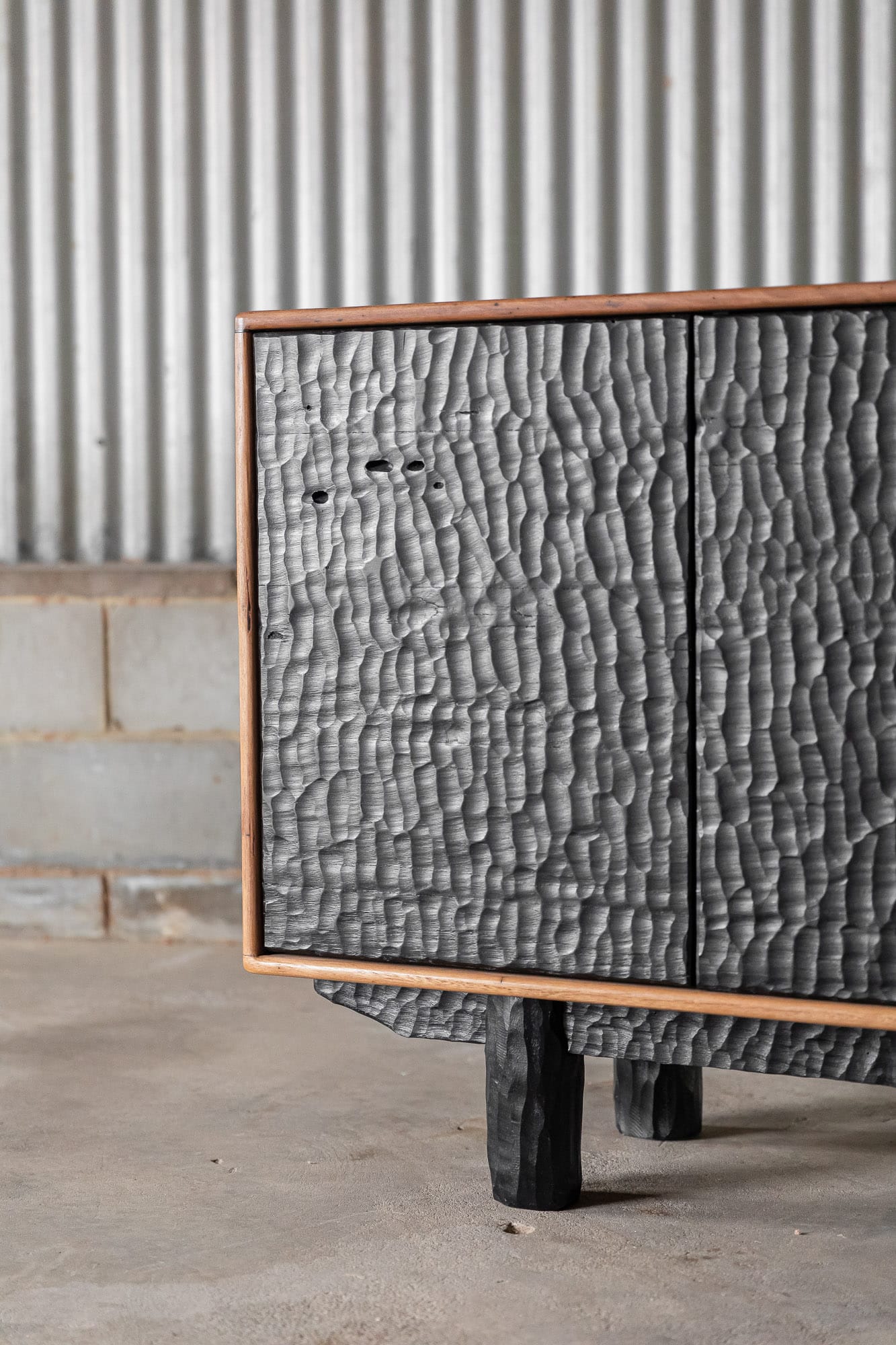 A detail shot of the sideboard by Two Blue Boys Furniture showing the black textured finish to the cupboard doors