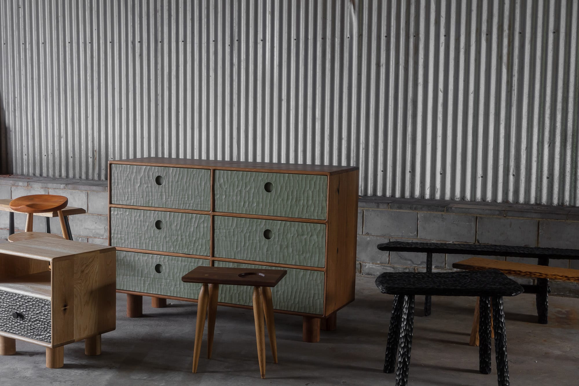 A collection shot of Two Blue Boys Furniture in the warehouse including stools, sideboards and bedside tables
