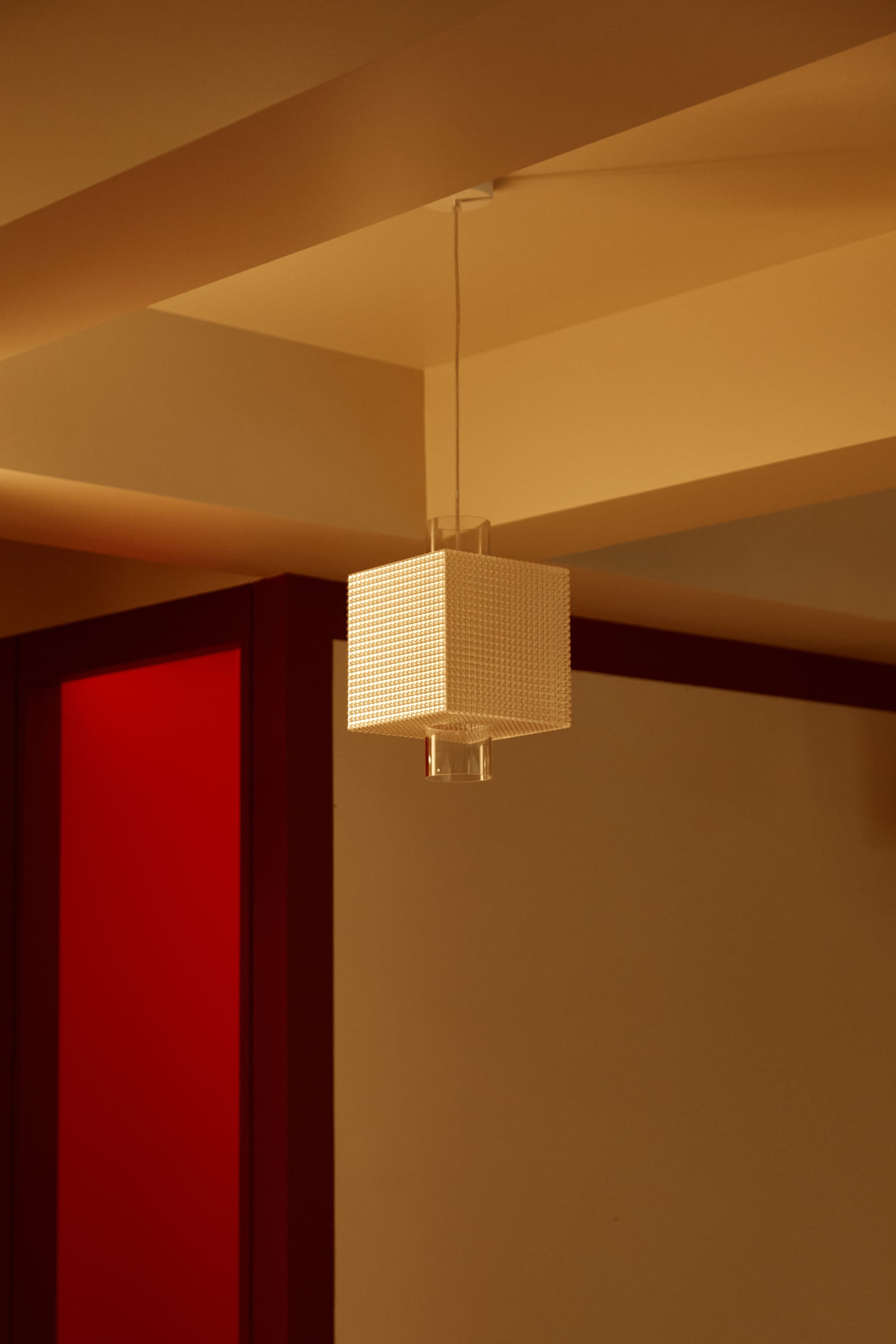 S'WICH Bondi by Studio Shand. Photography by Claudia Smith. White, square sculptural pendant light. Warm beige and red walls with brown trims. 