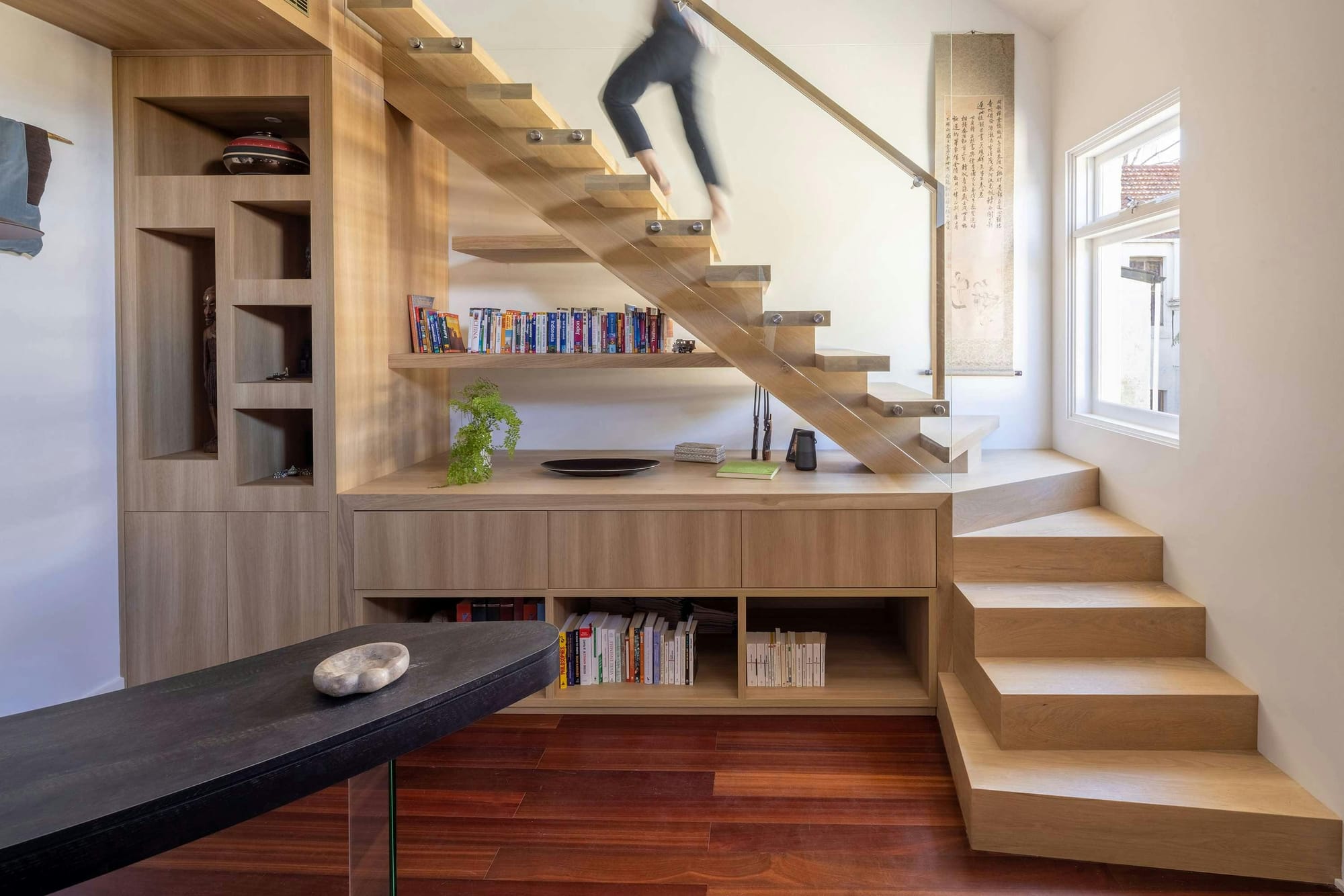 An interior shot of the new timber stair showing a person walking up