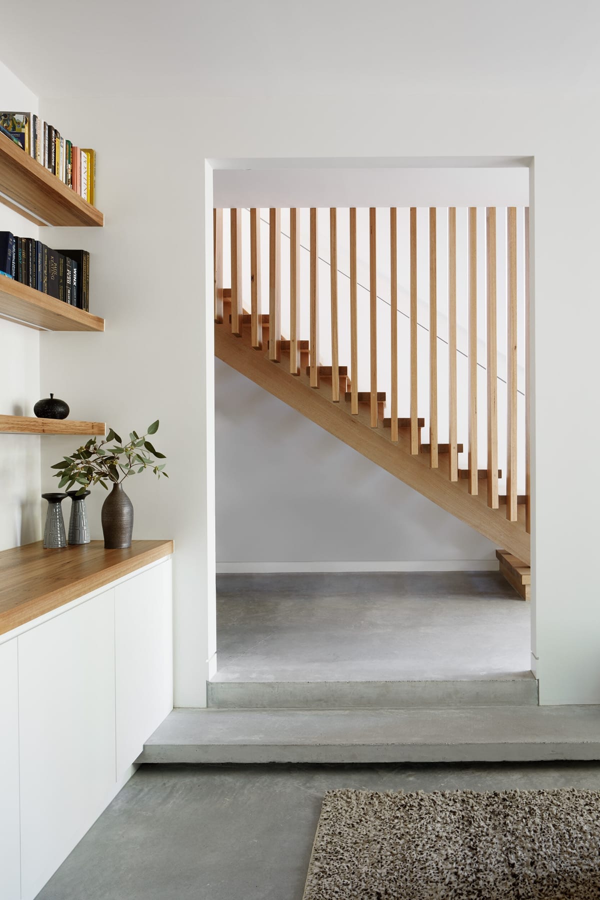 Laurel Grove by Kirsten Johnstone Architecture. Photography by Tatjana Plitt. Timber staircase through doorway. 