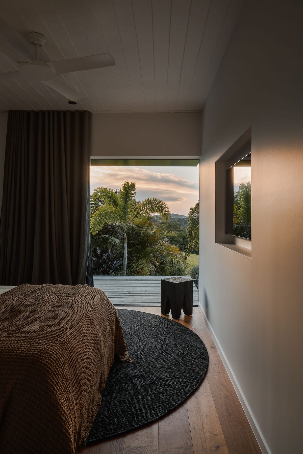Rockpool Farm Byron Bay. Photography by Andy Macpherson. Bedroom window overlooking hills at sunset.