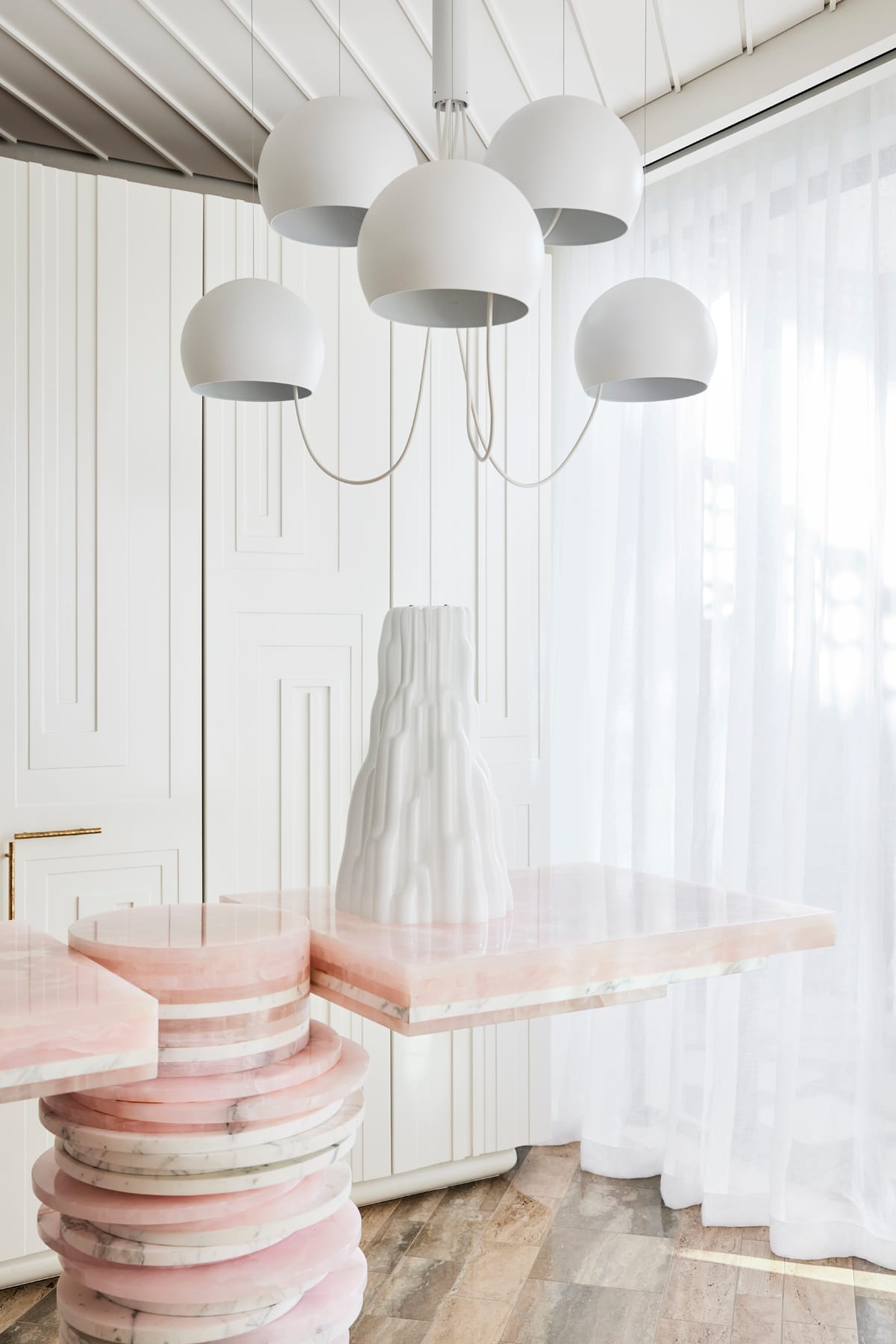 Toorak House 2 by K.P.D.O. Photography by Sharyn Cairns. White and pink stacked stone bar. White pendant light. Floor to ceiling white storage wall. 