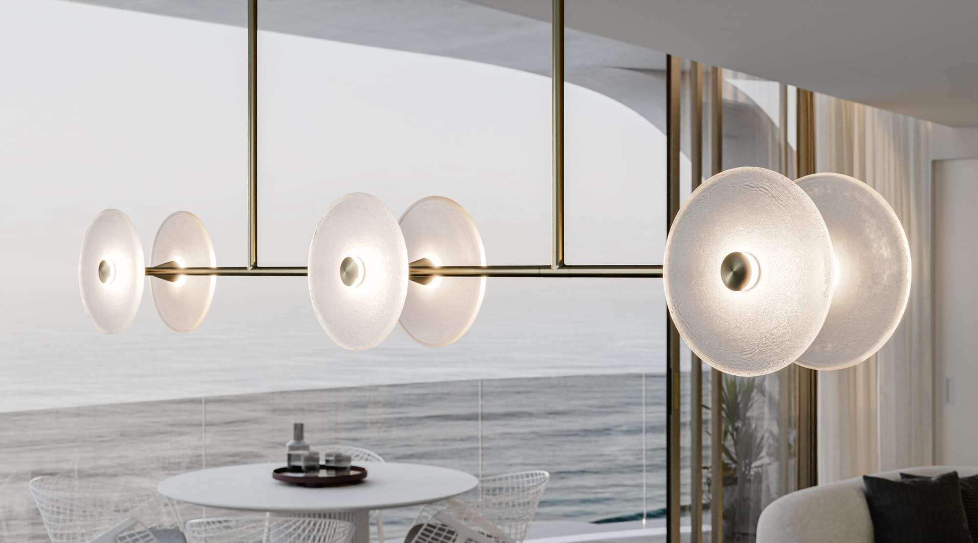 Coral Linear Road 6 Pendant Light by SOKTAS. Copyright of SOKTAS. Close up of gold and glass pendant light with 6 individual glass discs. 