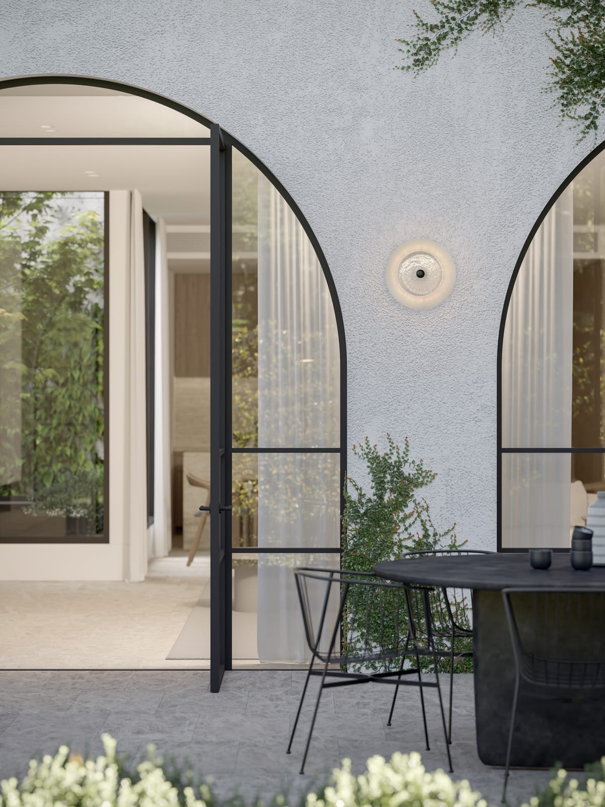 Coral Dome Wall Light by SOKTAS showing the light in an exterior courtyard on a white rendered wall