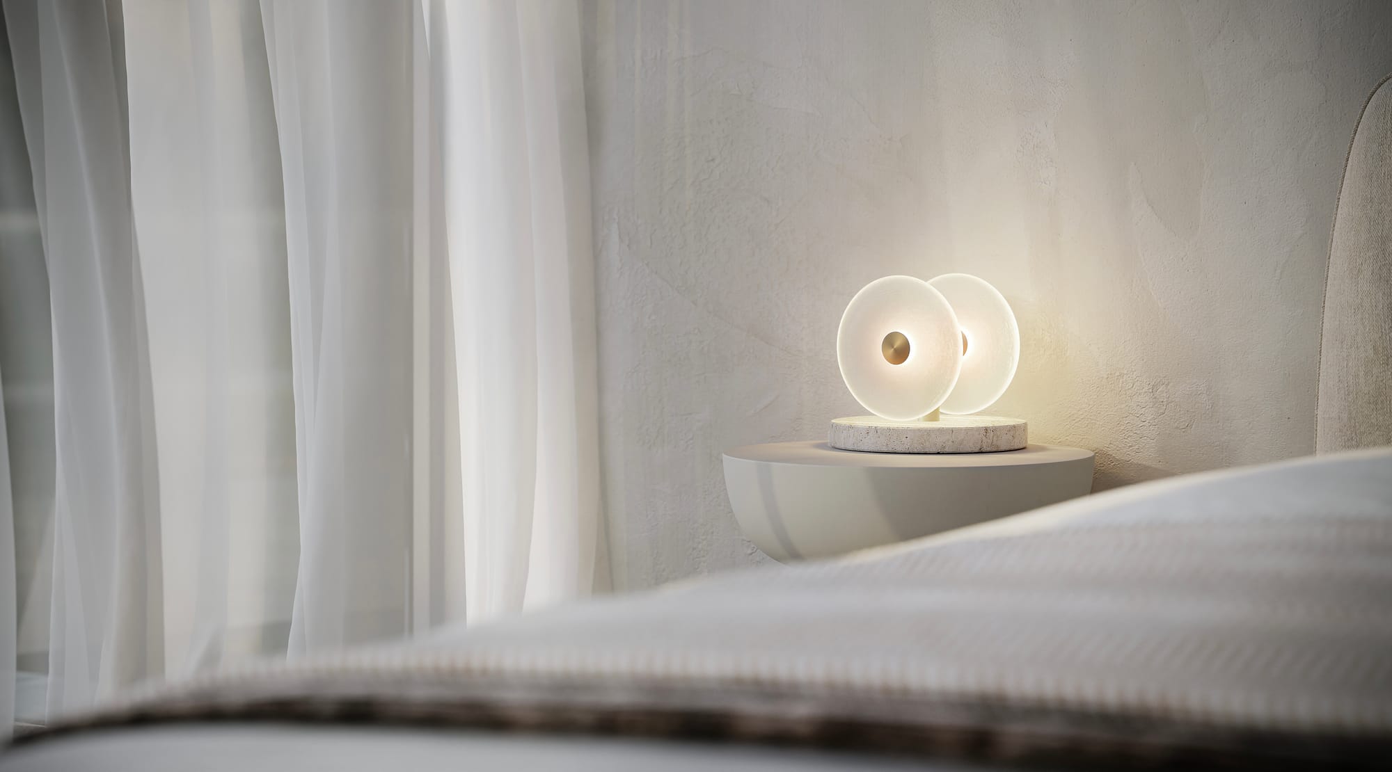 Coral Table Lamp by SOKTAS. Copyright of SOKTAS. Close up of bedside table lamp with stone base, gold stem and glass light. 