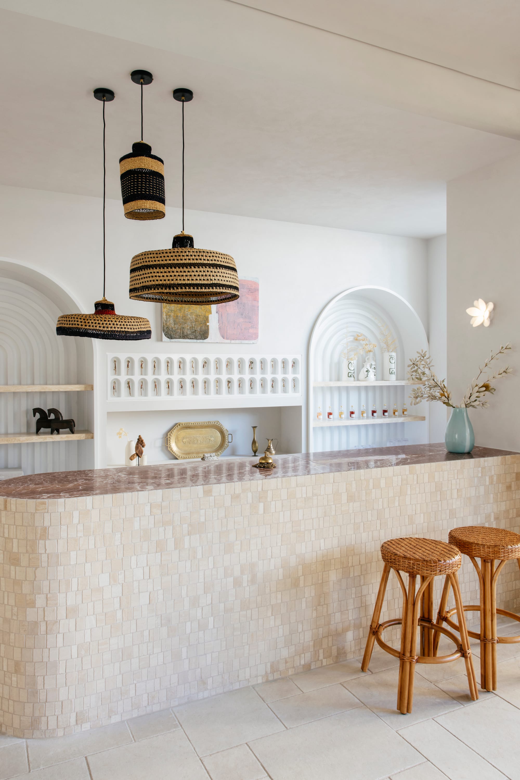 An interior shot of the communal area at BASQ House showing a tiled countertop and designer pendant lights hanging above