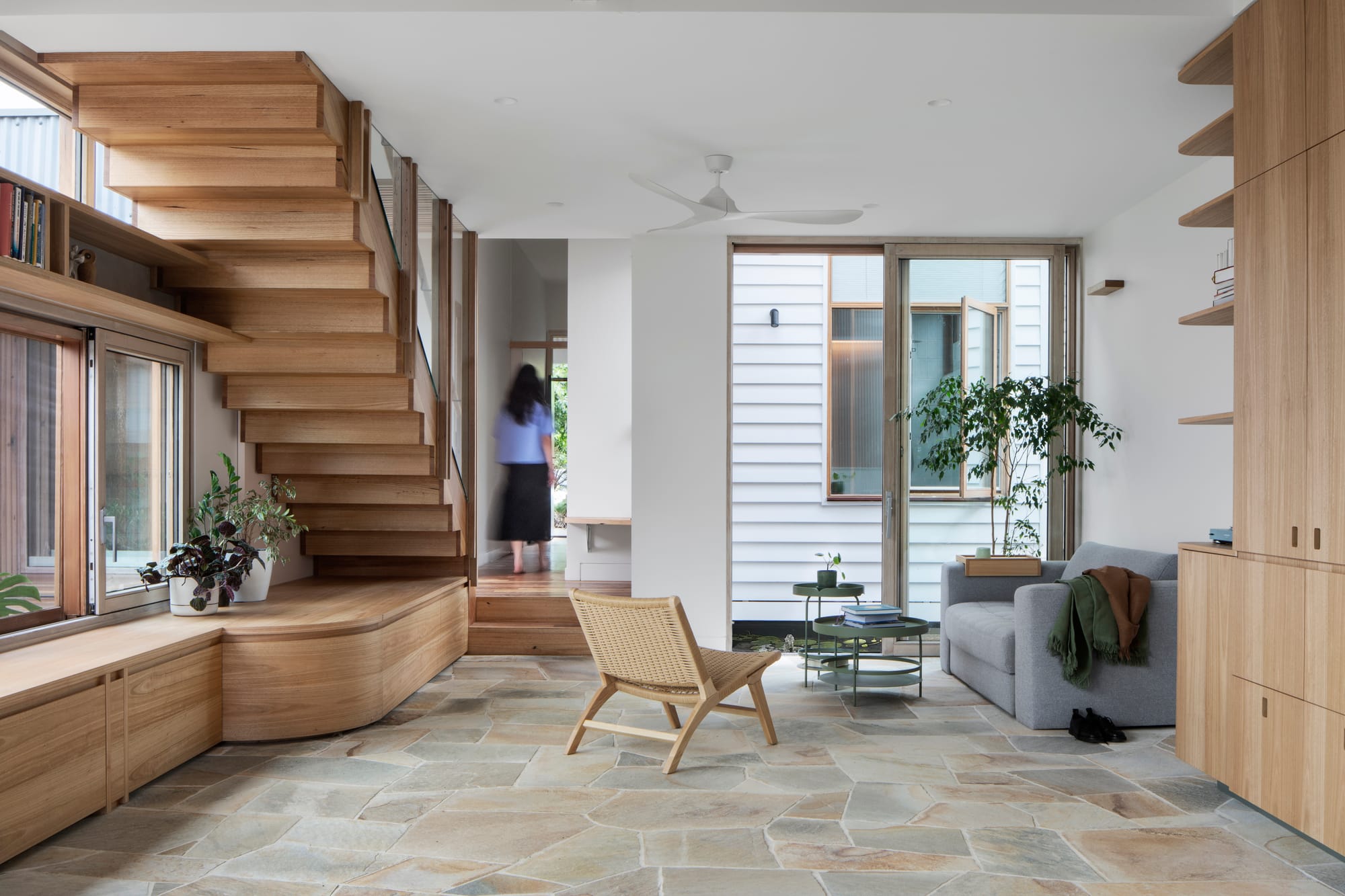 An interior shot of the living space and timber stair