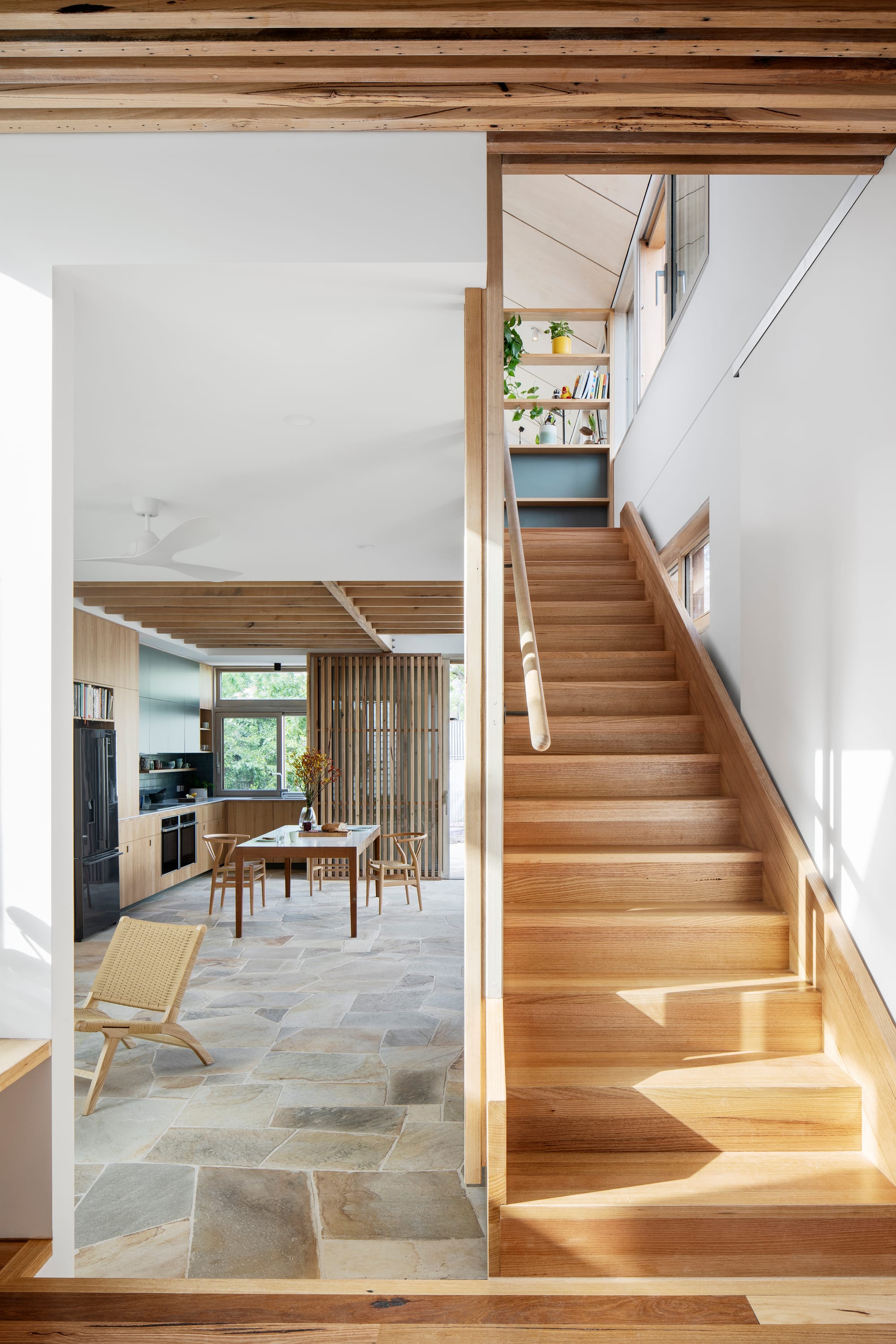 An interior shot showing the timber staircase and crazy paving floor to the communal areas