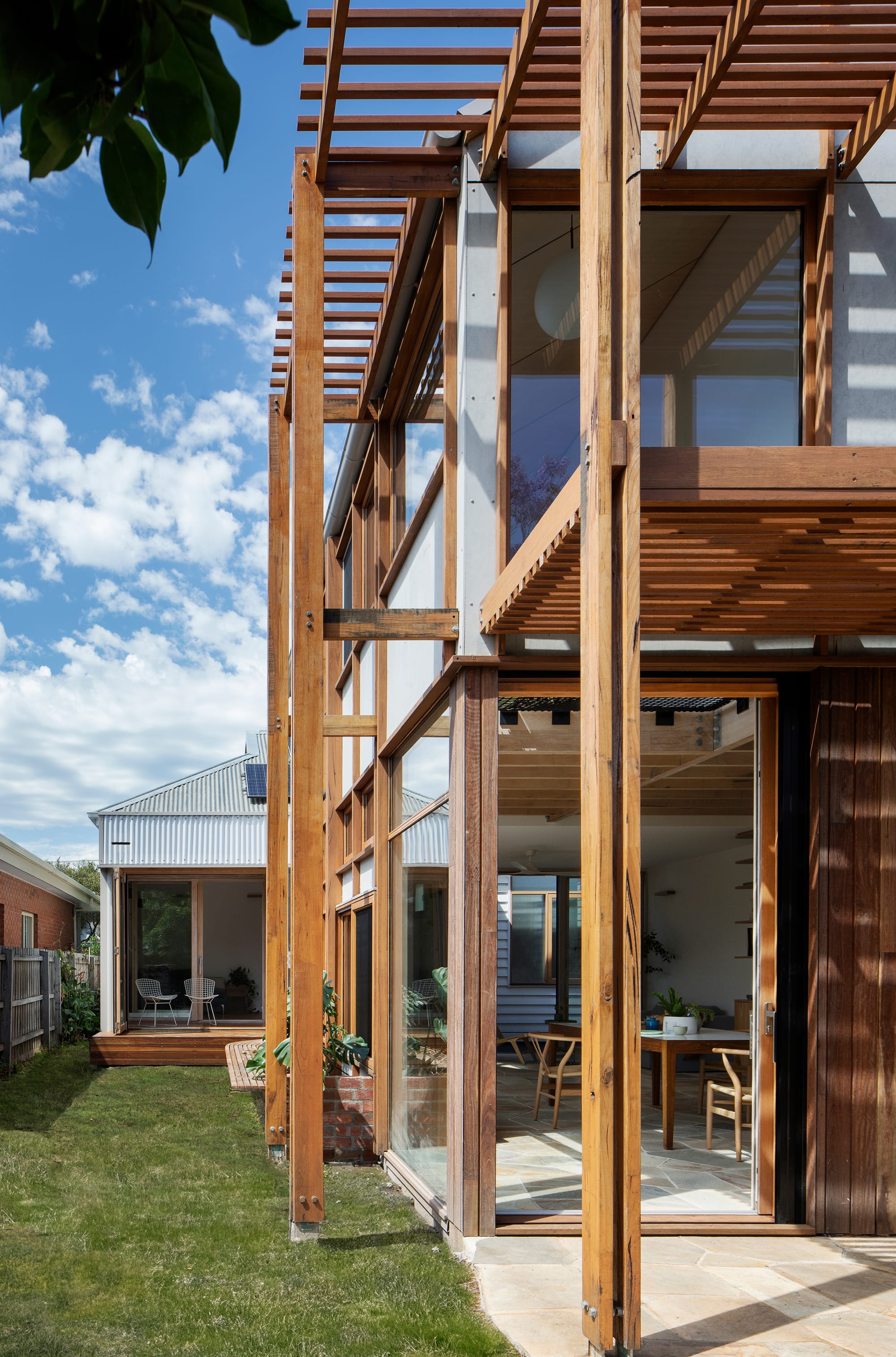 An exterior detail shot of the rear of the house showing the timberwork and timber doors and windows