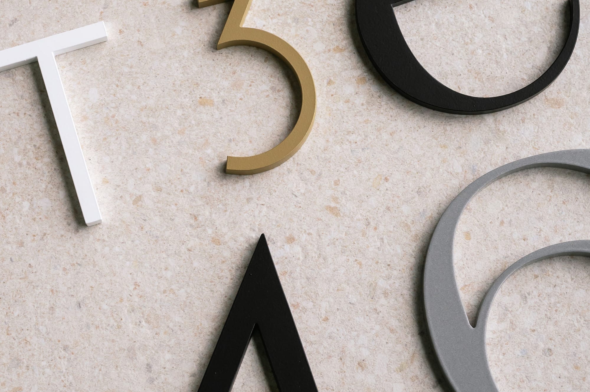 Peninsula House Numbers. Image copyright of Peninsula House Numbers. Various colour and font metal house numbers and letters.