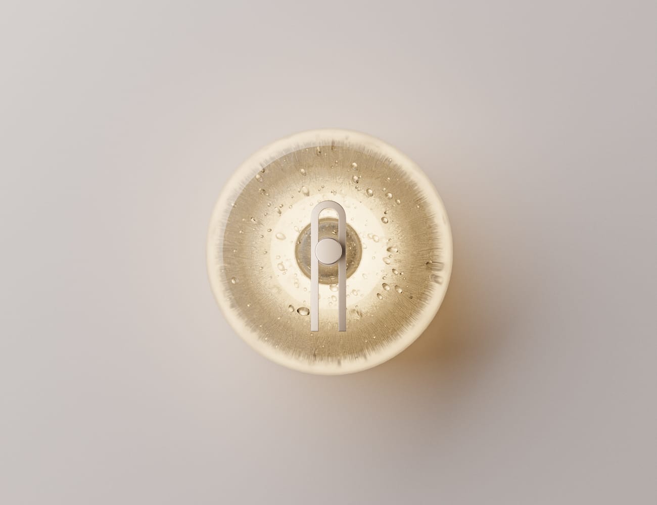 Point Five by South Drawn. Image copyright of South Drawn. Front on shot of circular wall sconce emitting warm light.
