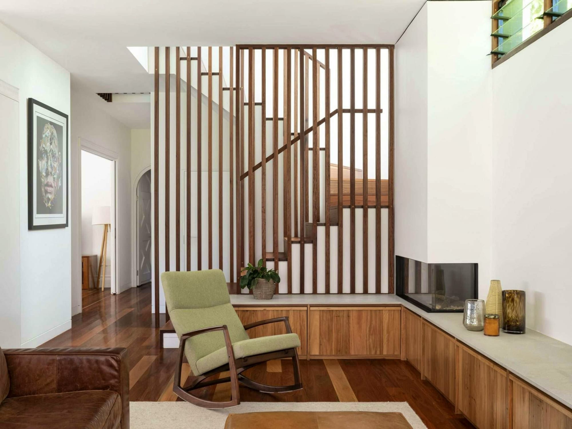 Surgo House by BILJ Architecture. Photography by Tom Ferguson. Mid-century modern living space with timber floors, cabinetry and dividing wall. Sage and walnut ricking hair. 