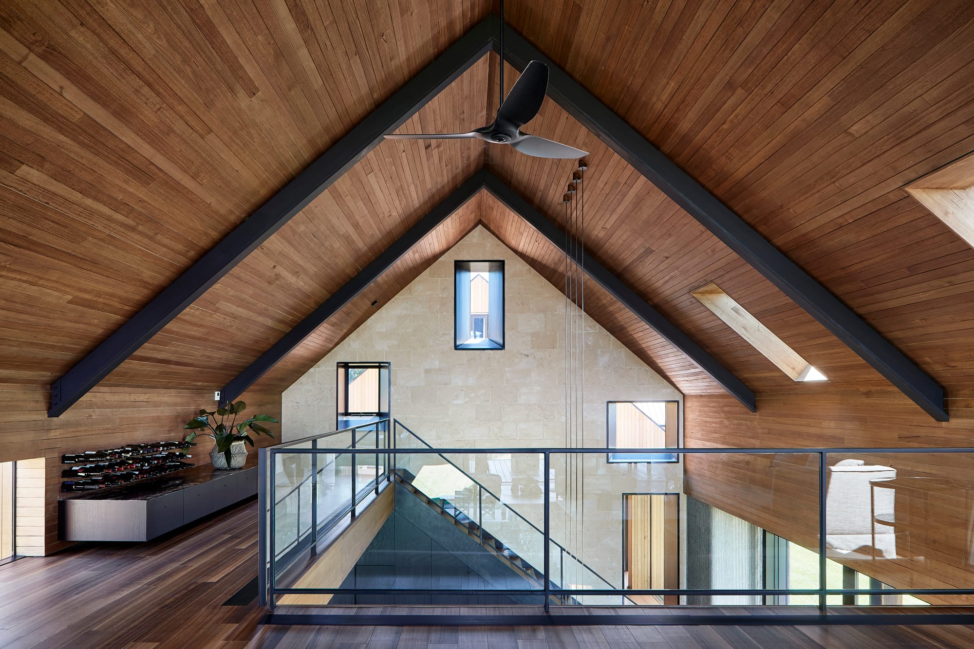 Multistorey residential home with large exposed void and walkways on second floor.