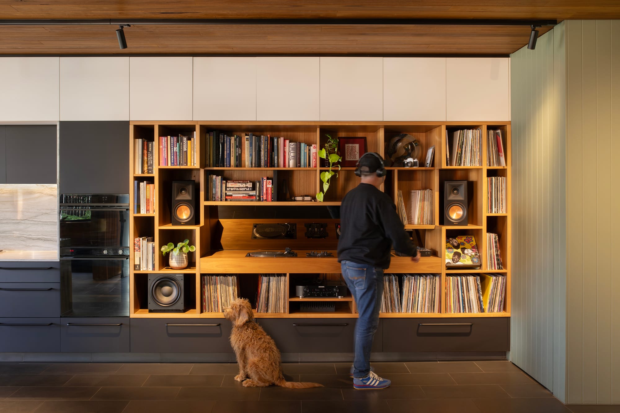 Cornerstone by Loupe Architecture. Photography by Alanna Jayne McTiernan. Vinyl and turntables library integrated in timber into kitchen wall.