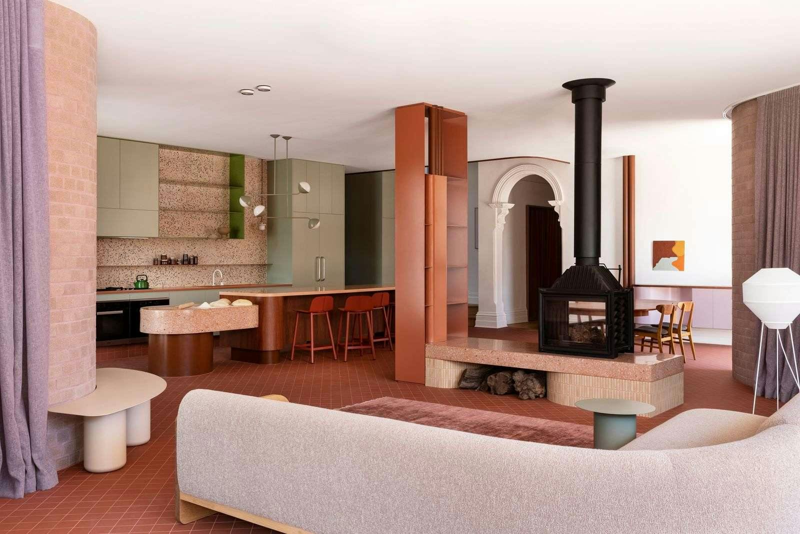 Hermon by WOWOWA. Living room and kitchen view featuring chimney, rich and earthy colors, brick pillars and floor long curtains.